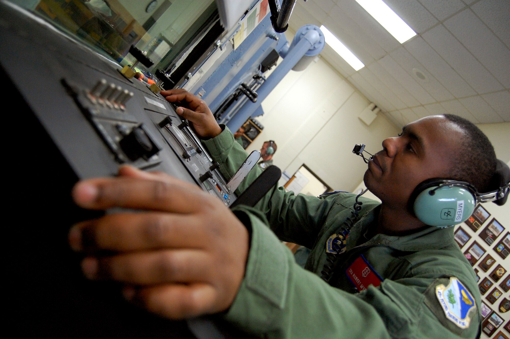 LAUGHLIN AIR FORCE BASE, Texas – Senior Airman Robert Myers, 47th Aeromedical Dental Squadron, mans the chamber’s lock station.  If a student pilot has a problem while the main chamber is “at altitude” and must return to ground level, Aerospace Physiology technicians will put them in the lock section to descend while continuing the main chamber flight. (U.S. Air Force photo by Staff Sgt. Austin M. May)