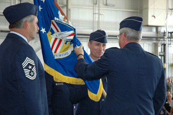 YOUNGSTOWN AIR RESERVE STATION, Ohio - Air Force Reserve Col. Karl McGregor accepts the 910th Airlift Wing's guidon, a flag bearing a military unit's crest, from Maj. Gen. Martin M. Mazick, commander of 22nd Air Force, during a change of command ceremony held here July 15. Col. McGregor succeeded Col. Tim Thomson who retired after 34 years of service to the Air Force. Col. McGregor takes command of the 910th after his most recent assignment as the operations group commander of the 439th Airlift Wing, Westover Air Reserve Base, Mass. U.S. Air Force photo/Tech. Sgt. Bob Barko Jr.