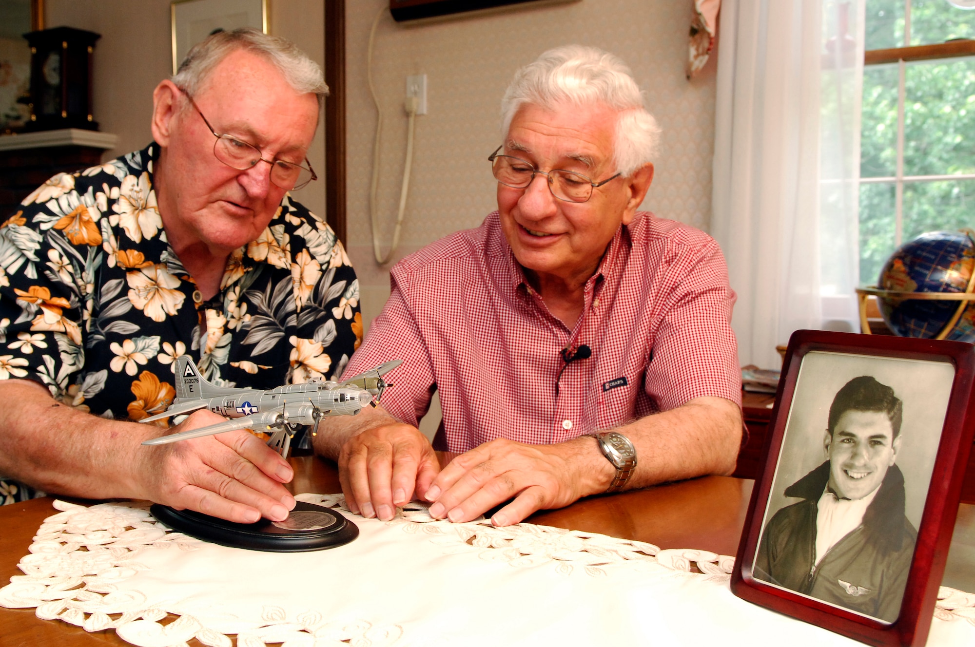 HANSCOM AFB, Mass. -- Tom Fahey Jr. and long-time friend Mike Modica reminisce about their days as B-17 gunners in the Army Air Corps during World War II. Both men were stationed in Italy with the 15th Air Force as staff sergeants serving on B-17 aircraft crews. Both Airmen also flew side-by-side with the 332nd Fighter Group of the Tuskegee Airmen. (U.S. Air Force photo by Mark Wyatt)
