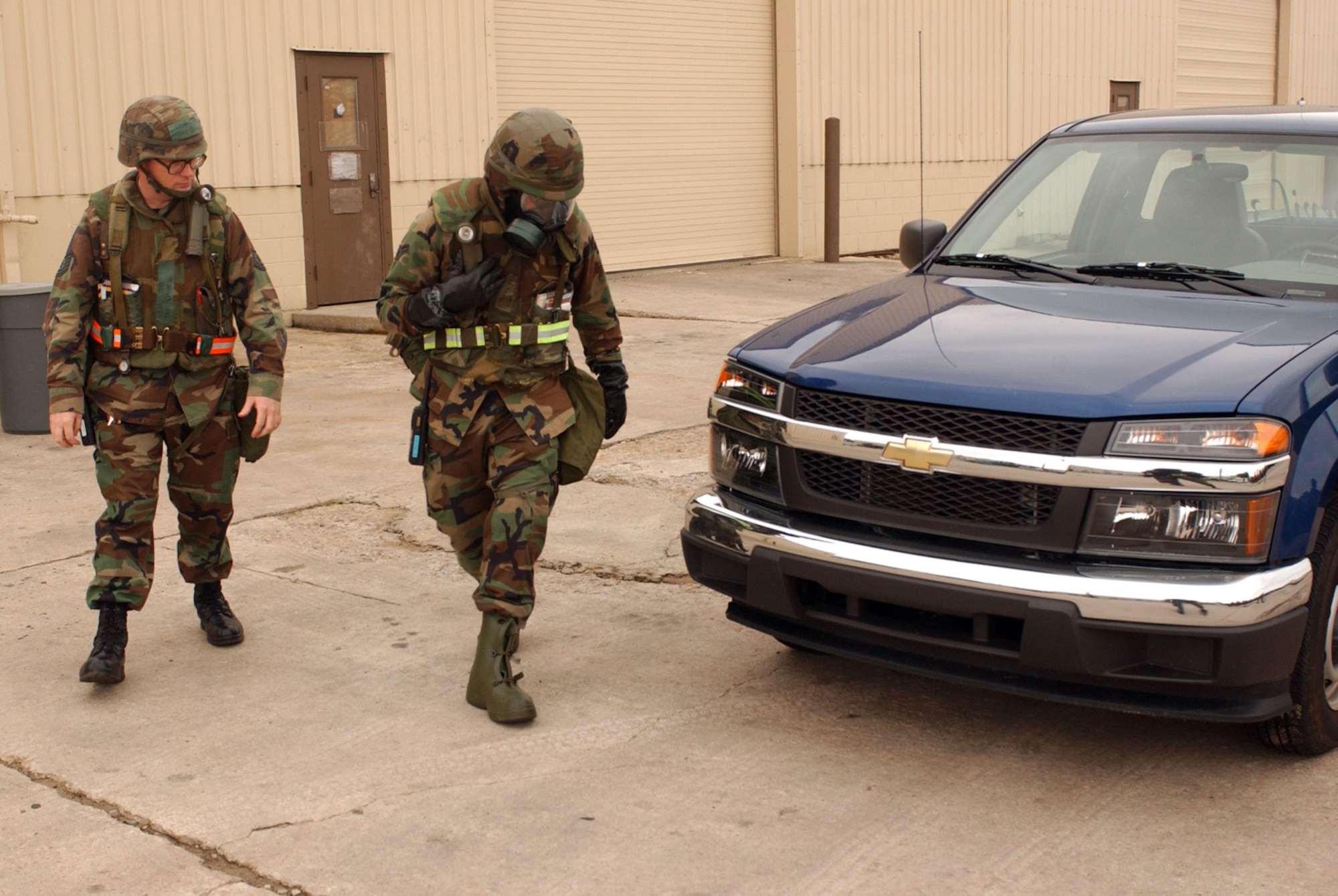 Tech. Sgt. Troy D'Angelo observes Airman 1st Class Justin Gatter perform a vehicle  inspection as part of his chemical warfare vehicle training on July 16.  The two-day exercise prepares 8th Fighter Wing Airman for the upcoming Korean peninsula exercise next week along with potential real world scenarios. Both Airmen are assigned to the 8th Civil Engineer Squadron. (U.S. Air Force Photo/Senior Airman Steven R. Doty)                              