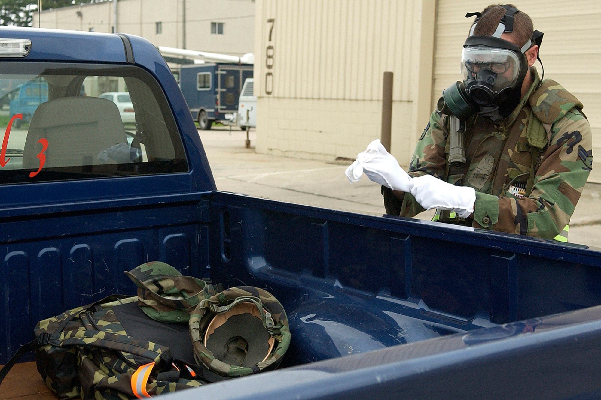 Airman 1st Class Gatter Justin, 8th Civil Engineer Squadron, puts on his chemical warfare gear to complete driver training during Wolf War Days exercise on July 16, 2007.  The two-day exercise prepares 8th Fighter Wing Airman for the upcoming Korean peninsula exercise next week along with potential real world scenarios. (U.S. Air Force photo by Senior Airman Giang Nguyen)                             