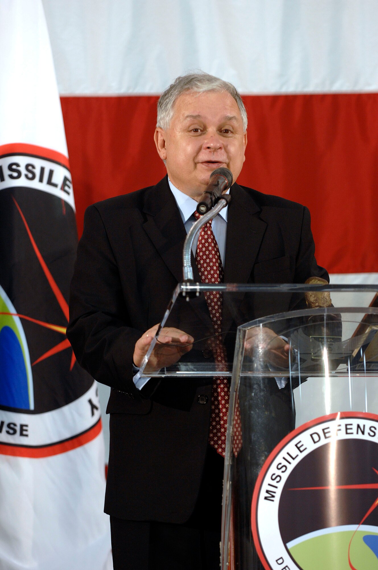 VANDENBERG AIR FORCE BASE, Calif. -- Polish President Lech Kaczynski speaks at a press conference in the 76th Helicopter Squadron hangar on July 17 following a tour of missile defense facilities and meeting with Missile Defense Agency officials. The trip gave the president an opportunity to get an impression of the MDA program at a time when Polish and U.S. governments are negotiating a missile defense system in Poland. President Kaczynski came to Vandenberg two days after holding diplomatic discussions with U.S. President George W. Bush in Washington, D.C. (U.S. Air Force photo/Tech. Sgt. William Greer)