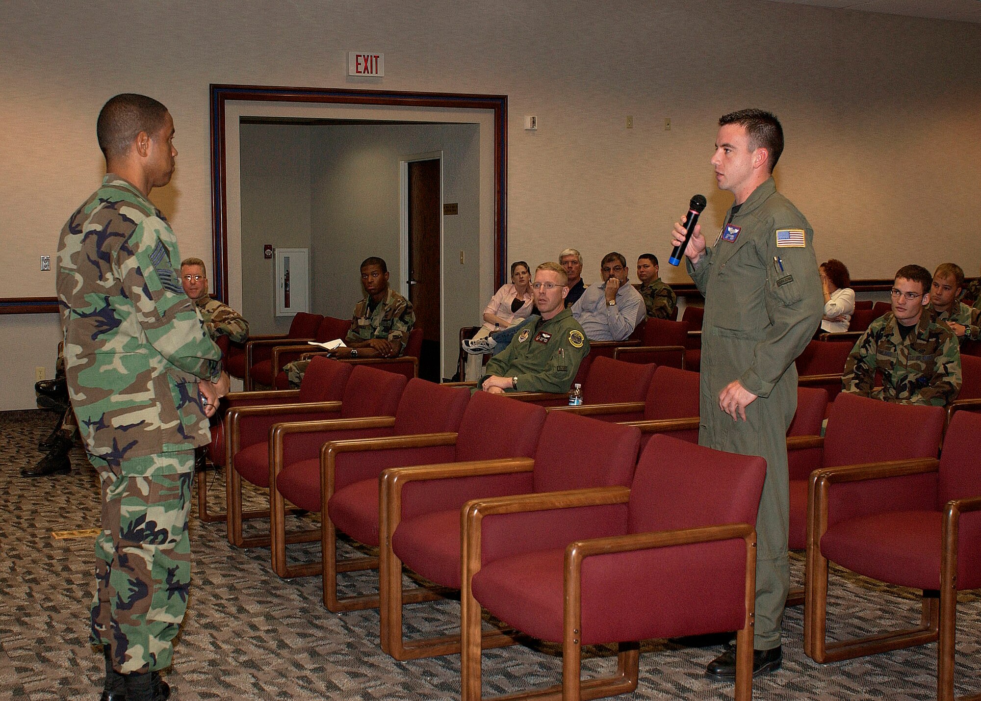 Staff Sgt. Cy Eckhardt (right), a boom operator with the 445th Flight Test Squadron, asks a question of Chief Master Sgt. Terrence Reed (left), Air Force Personnel Center command chief, during the Air Force 60th Anniversary Lecture Series on July 12. During the lecture, Chief Reed discussed changes in how military personnel flights around the Air Force will perform their mission in the future. (Courtesy photo)