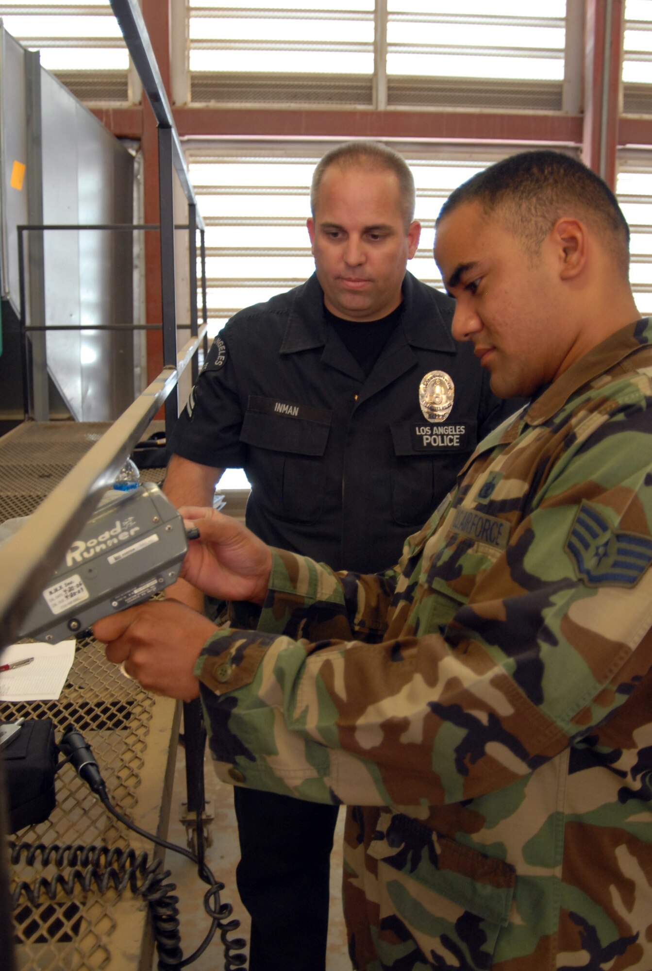 Staff Sgt. Martin Seau, 95th Security Forces Squadron patrolman, receives light detection and ranging unit training from Los Angeles Police Department Officer Don Inman during the radar and LIDAR procedures seminar July 12. The five-day training course included calibration and operation procedures for both handheld and vehicle-mounted radar and LIDAR units. (Photo by Tech. Sgt. Jay Fury)