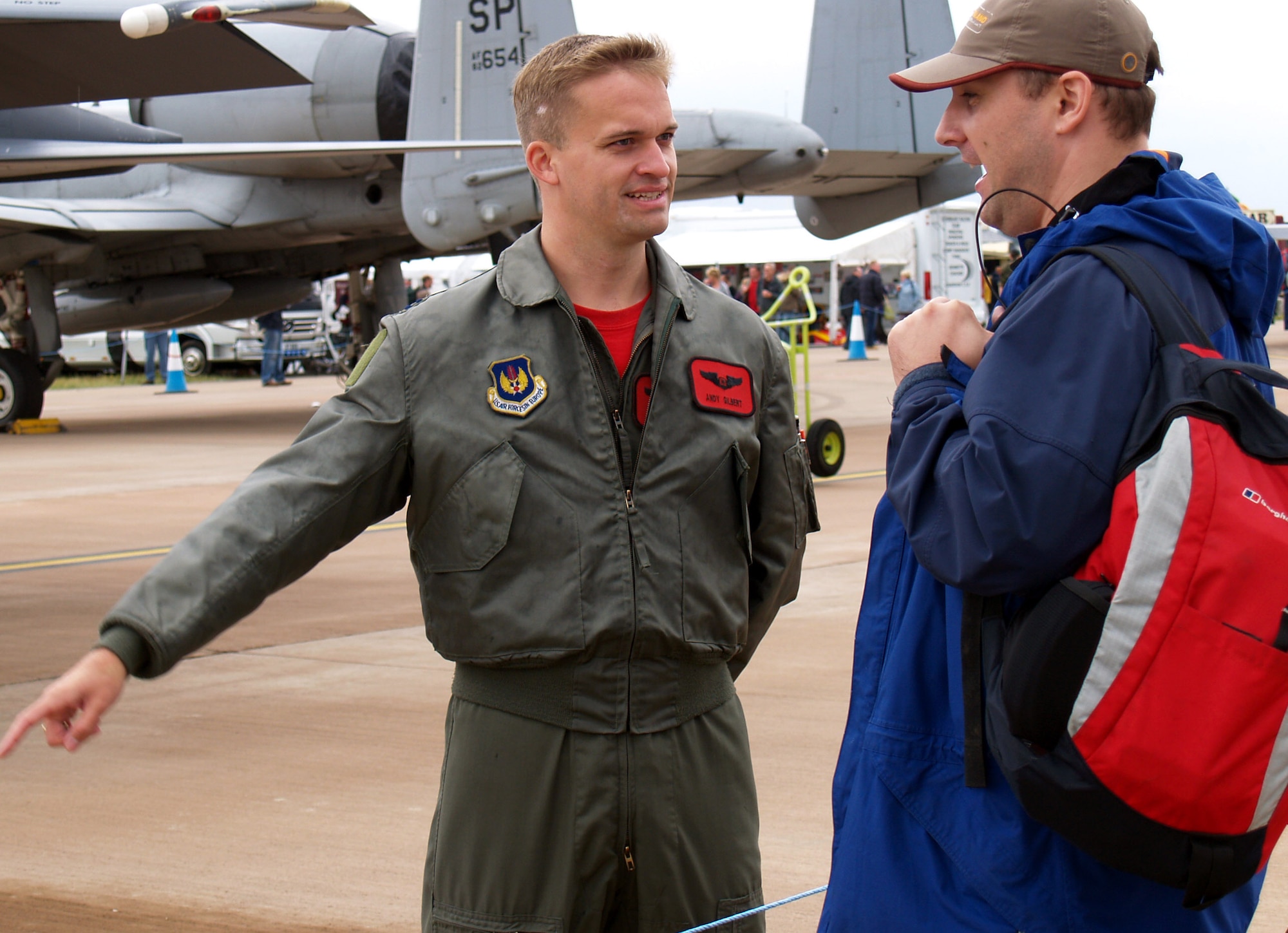 Captain Andy Gilbert, an F-15E Strike Eagle weapons system officer with the 494th Fighter Squadron from Royal Air Forces Lakenheath, England, chats with spectator James Denning July 15 at the Royal International Air Tattoo at RAF Fairfield. (U.S. Air Force photo/Tech. Sgt Carl E. Rishkofski) 

