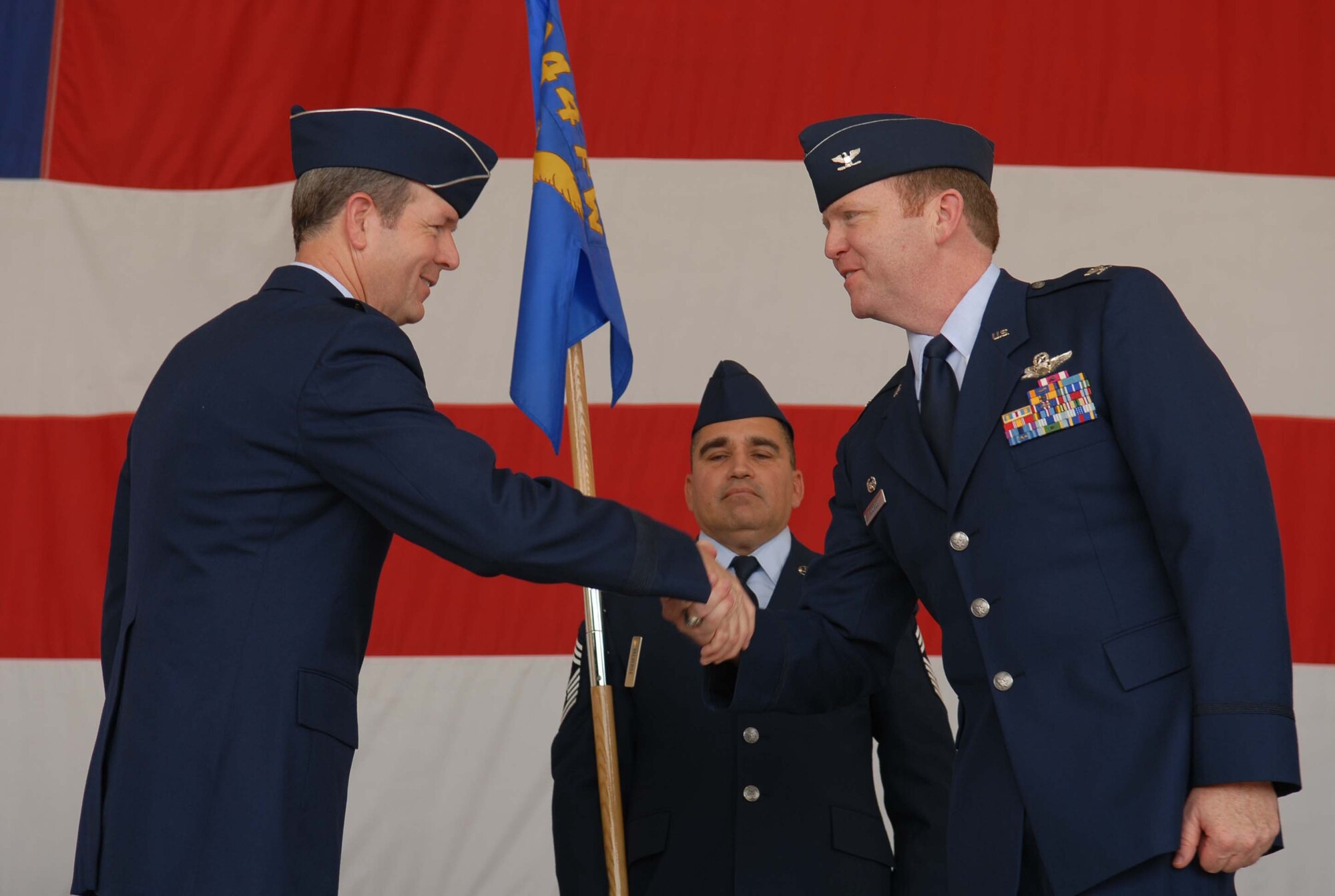 Brig. Gen. Thomas Coon, 10th Air Force commander, congratulates Col. Richard Scobee as he takes command of the 944th Fighter Wing on July 14. (U.S. Air Force photo/Airman Gustavo Gonzalez)