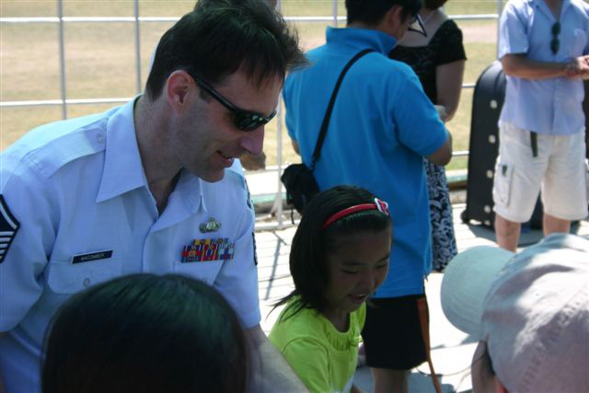ULAANBATAAR, Mongolia -- Master Sgt. Dean McComber of the USAF Band of the Pacific-Asia interacts with a student from the International Children's Centre "Nairamdal" (youth camp) July 4.