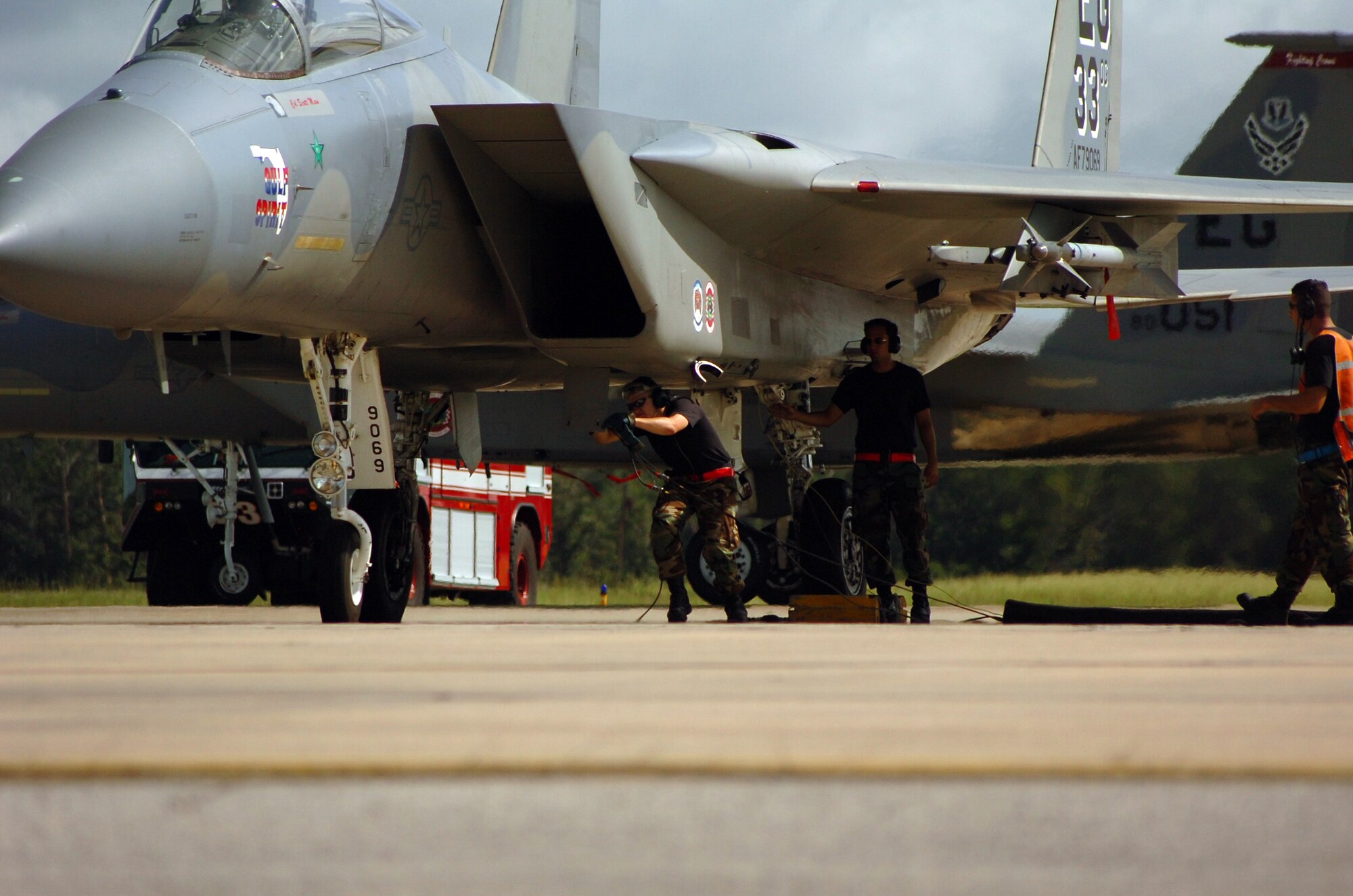 Crew chiefs from the 60th Aircraft Maintenance Unit check an F-15C Eagle during surge operations July 17 at Eglin Air Force Base, Fla. During surge operations, flying takes place throughout the day from early morning to dusk. Surges are used to help the wing simulate wartime flying. The intensified flying also benefits the wing in all facets of training. The 33d Fighter Wing is conducting surge operations July 17 through July 19. During a normal surge, 15-20 jets will take off, fly a mission, land and refuel then take off again in rapid rotation up to three times. Up to 100 sorties in a day's time may be flown. (U.S. Air Force photo by Staff Sgt. Bryan Franks)
