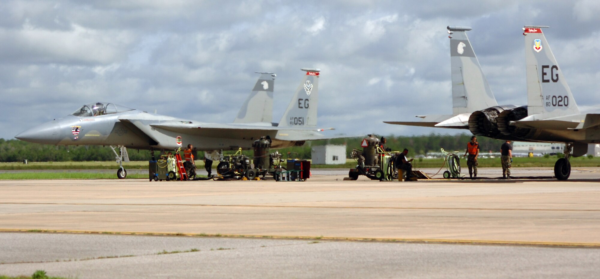 Crew chiefs from the 60th Aircraft Maintenance Unit prepare F-15C Eagles for the next set of sorties during surge operations July 17 at Eglin Air Force Base, Fla. During surge operations, flying takes place throughout the day from early morning to dusk. Surges are used to help the wing simulate wartime flying. The intensified flying also benefits the wing in all facets of training. The 33d Fighter Wing is conducting surge operations July 17 through July 19. During a normal surge, 15-20 jets will take off, fly a mission, land and refuel then take off again in rapid rotation up to three times. Up to 100 sorties in a day's time may be flown. (U.S. Air Force photos by Staff Sgt. Bryan Franks)
