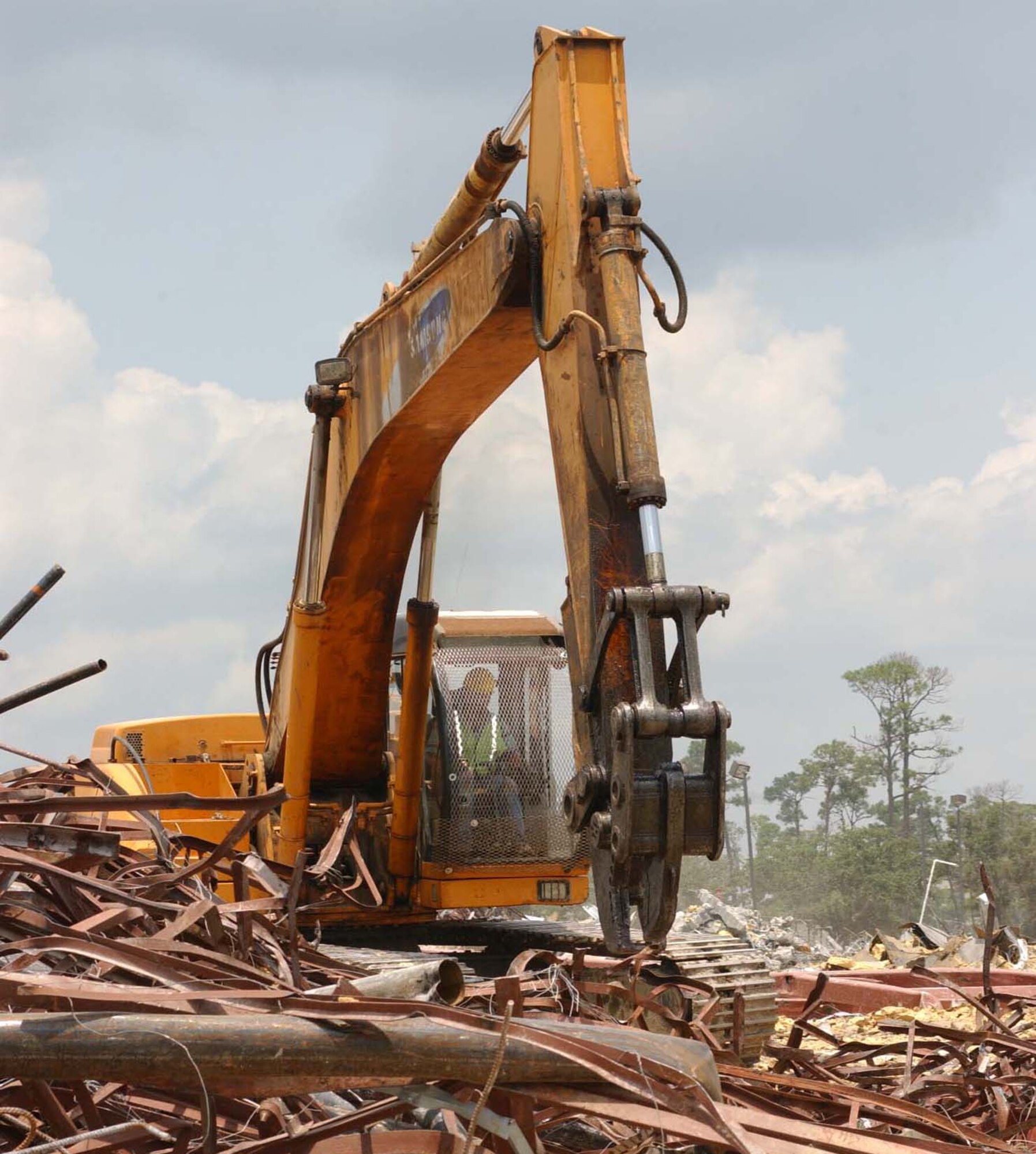 David Arreola, GNC Construction Co., separates debris from the demolished base exchange with an excavator.  (U.S. Air Force photo by Kemberly Groue)