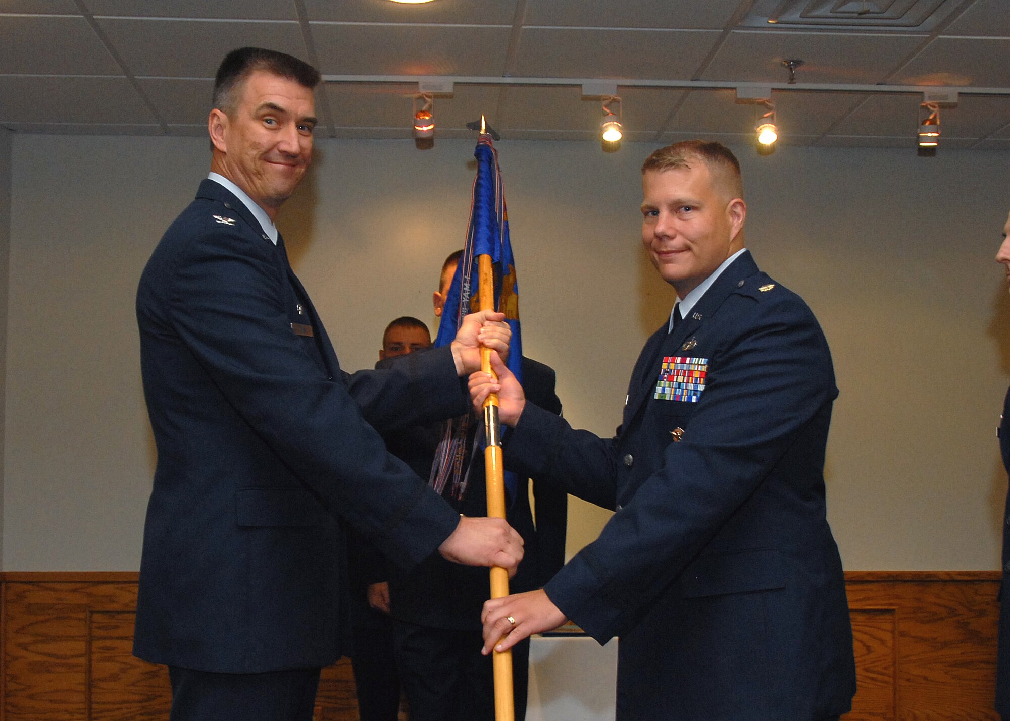 Col. Steven McKay, 82nd Mission Support Group commander, presents the guidon to incoming 82nd Security Forces Commander Maj. William Lowery at the 82nd SFS change-of-command ceremony July 16. (U.S. Air Force photo/Mike Litteken )