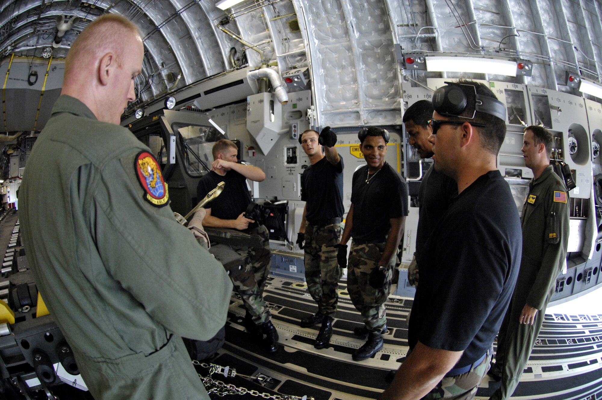 HICKAM AIR FORCE BASE, Hawaii -- Rodeo team members practice tying down equipment on a C-17 Globemaster III during a rodeo practice here July 13. Members from the 535th Airlift Squadron and 15th Logistics Readiness Squadron, Combat Mobility Element are practicing for upcoming Air Mobility Command Rodeo at McChord Air Force Base, Wash. (U.S. Air Force photo/Tech. Sgt. Shane A. Cuomo)