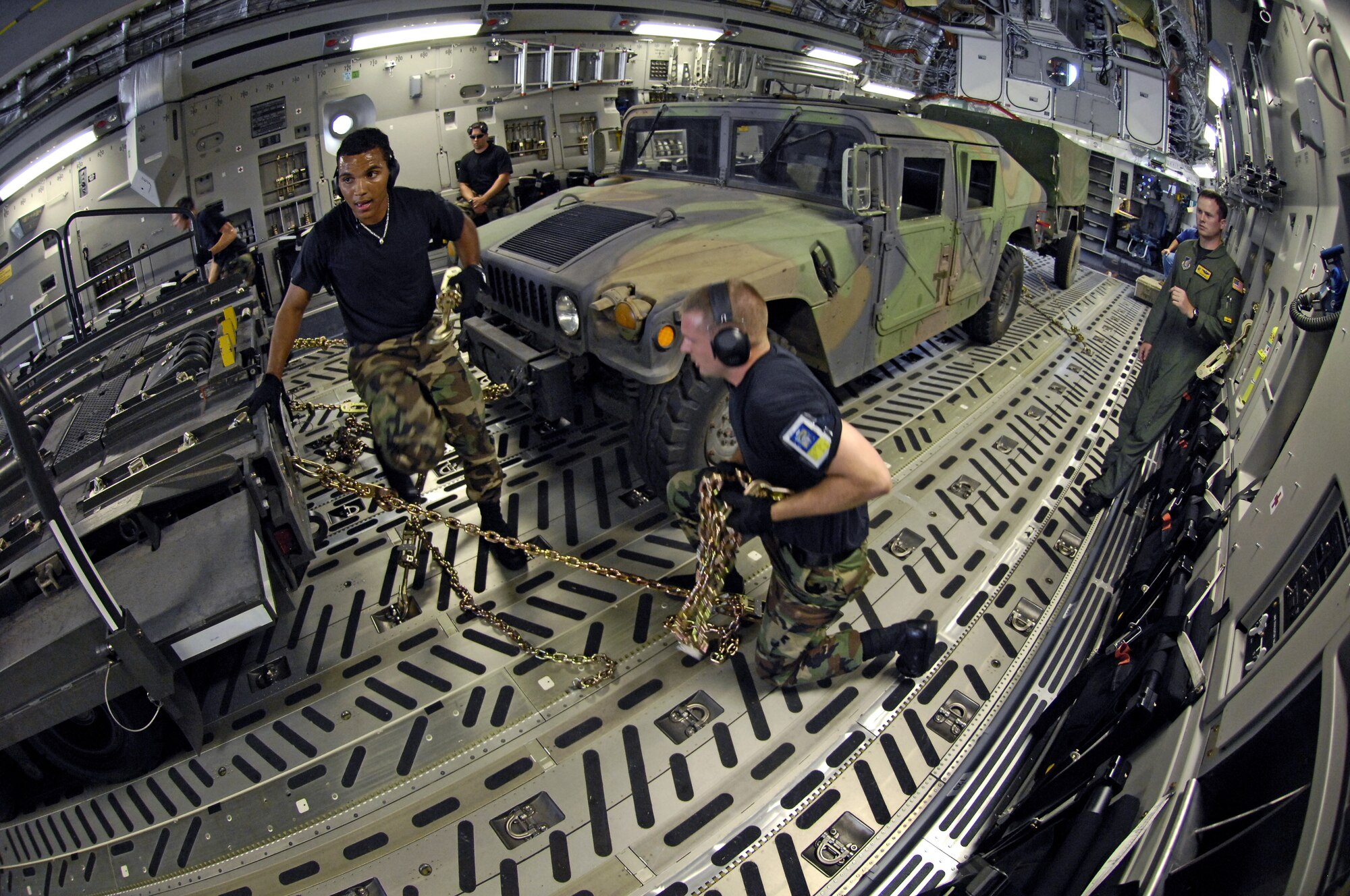 HICKAM AIR FORCE BASE, Hawaii -- Rodeo team members practice tying down equipment on a C-17 Globemaster III during a rodeo practice here July 13. Members from the 535th Airlift Squadron and 15th Logistics Readiness Squadron, Combat Mobility Element are practicing for upcoming Air Mobility Command Rodeo at McChord Air Force Base, Wash. (U.S. Air Force photo/Tech. Sgt. Shane A. Cuomo)