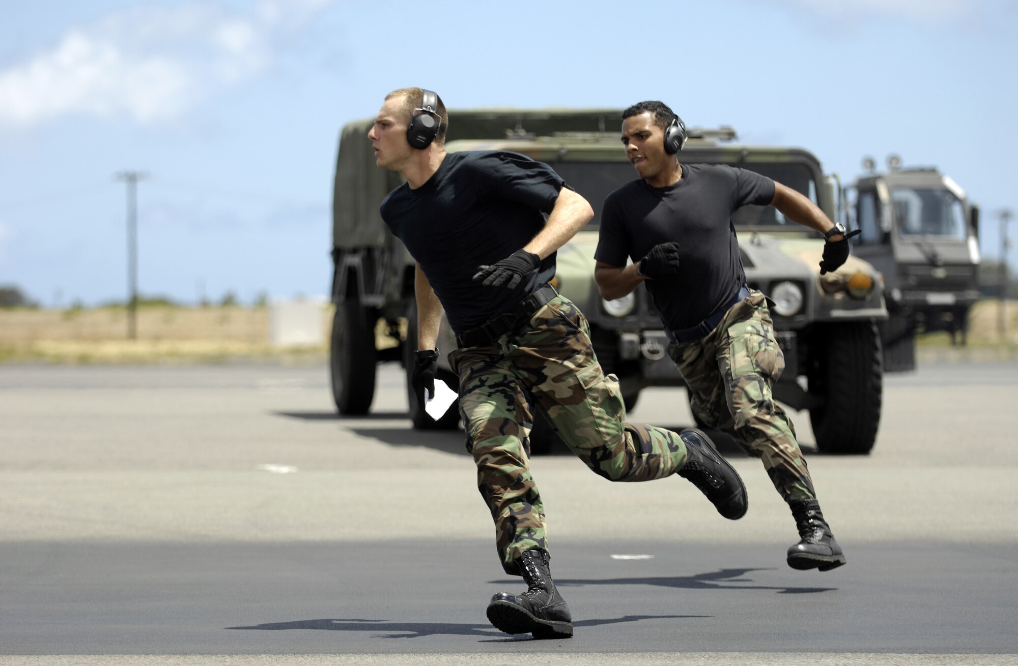 HICKAM AIR FORCE BASE, Hawaii -- Airman 1st Class Trever Bush and Airman 1st Class Daray Davis sprint to a C-17 Globemaster III during a rodeo practice here July 13. The Airmen are from the 15th Logistics Readiness Squadron, Combat Mobility Element and are part of Hickam’s Rodeo team. The team is practicing for the upcoming Air Mobility Command Rodeo at McChord Air Force Base, Wash. (U.S. Air Force photo/Tech. Sgt. Shane A. Cuomo)