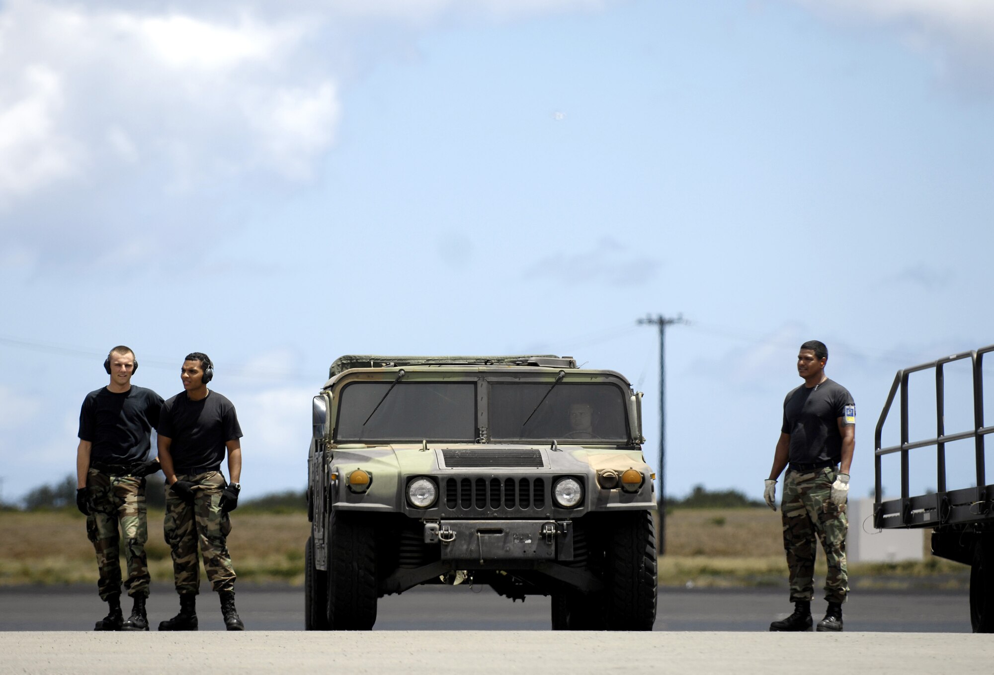 HICKAM AIR FORCE BASE, Hawaii -- Rodeo team members wait to begin loading equipment on a C-17 Globemaster III during a rodeo practice here July 1 3. Members from the 535th Airlift Squadron and 15th Logistics Readiness Squadron, Combat Mobility Element are practicing for upcoming Air Mobility Command Rodeo at McChord Air Force Base, Wash. (U.S. Air Force photo/Tech. Sgt. Shane A. Cuomo)