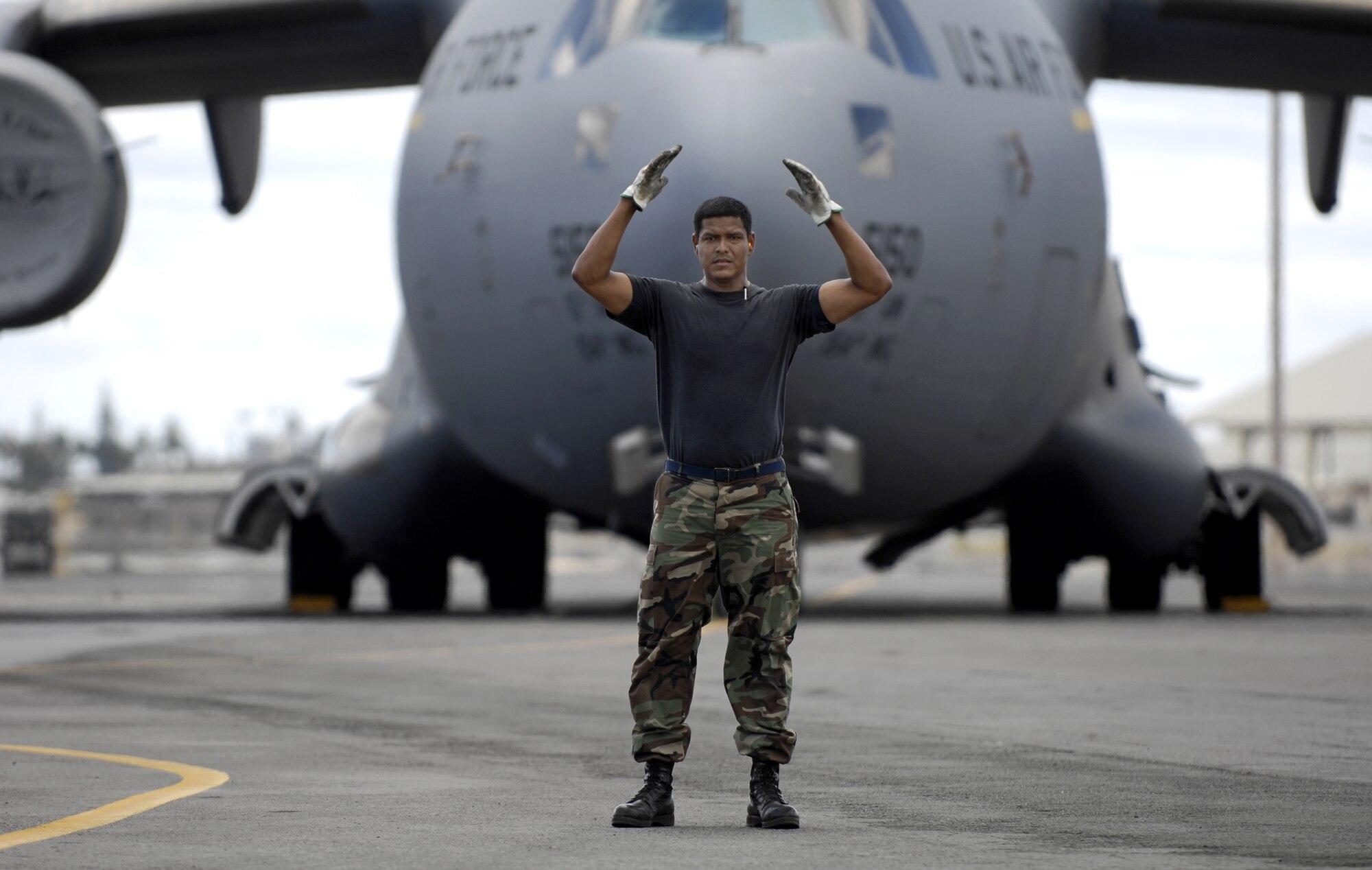 HICKAM AIR FORCE BASE, Hawaii -- Master Sgt. Greg Martinez guides a K-Loader off of a C-17 Globemaster III during a rodeo practice here July 13.  Sergeant Martinez is from the 15th Logistics Readiness Squadron, Combat Mobility Element and is part of Hickam’s Rodeo team. The team is practicing for the upcoming Air Mobility Command Rodeo at McChord Air Force Base, Wash. (U.S. Air Force photo/Tech. Sgt. Shane A. Cuomo)