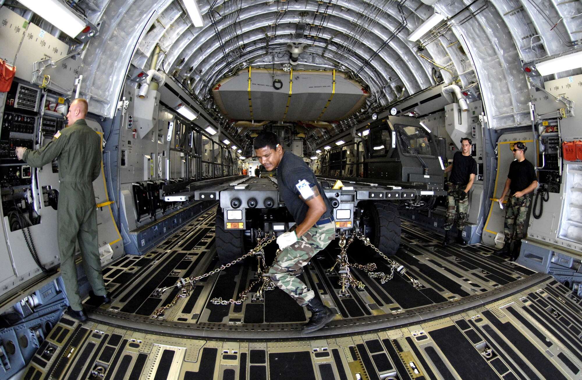 HICKAM AIR FORCE BASE, Hawaii -- Rodeo team members tie down a K-Loader on a C-17 Globemaster III during a rodeo practice here July 13. Members from the 535th Airlift Squadron and 15th Logistics Readiness Squadron, Combat Mobility Element are practicing for upcoming Air Mobility Command Rodeo at McChord Air Force Base, Wash. (U.S. Air Force photo/Tech. Sgt. Shane A. Cuomo)