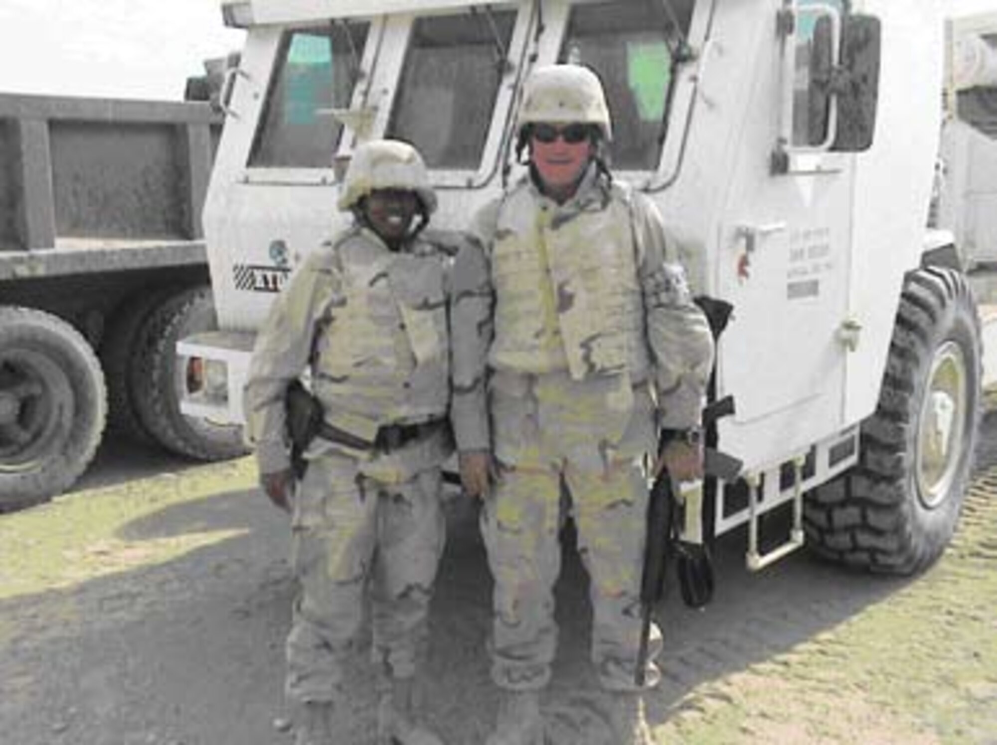 First Lieutenant Shawntara Govan and Mr. William Lewis, of AFRL’s Materials and Manufacturing Directorate, stand in front of remote-controlled Mine Area Clearance Equipment at Bagram Air Base, Afghanistan.  