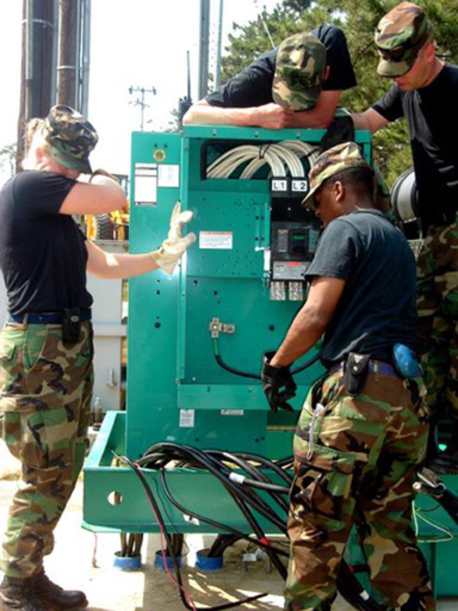 GRISSOM AIR RESERVE BASE, Ind  -- Members of the 434th Civil Engineering Squadron install wires to hook up a 350 Kilowatt generator at the water treatment plant at Kunsan Air Base, Korea.  Members of the 434th CES deployed to Korea to train and put their skills to use. (Air Force photo)