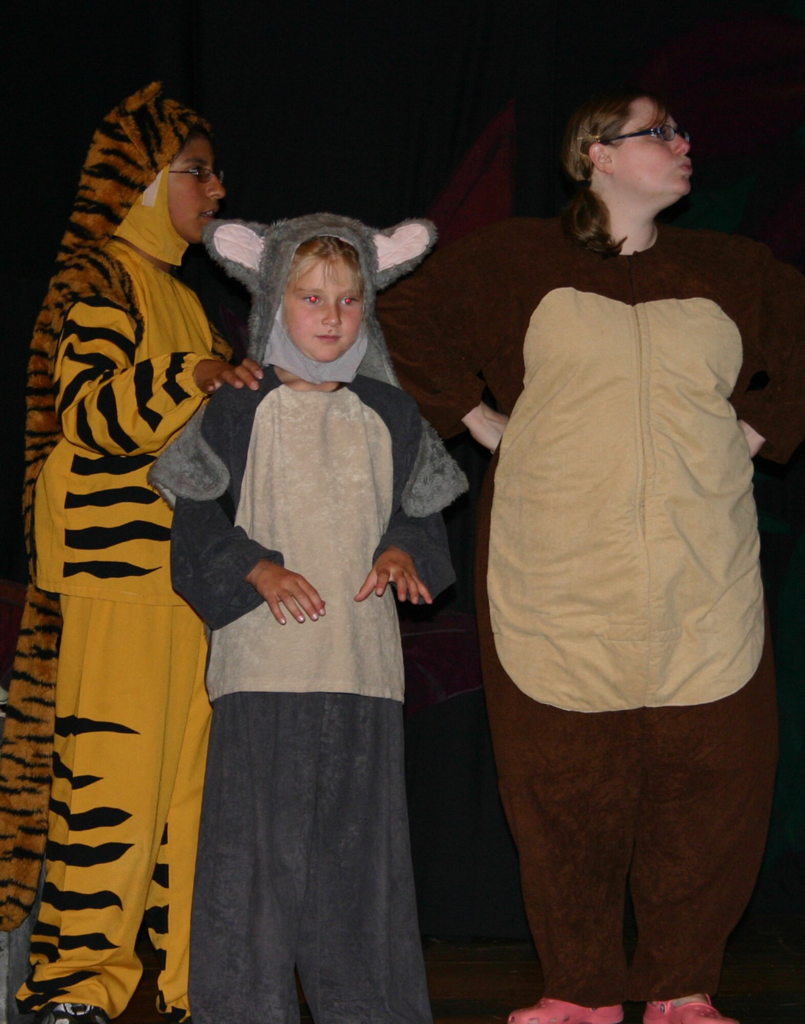From left to right: Patricia Romero, Alison Brewer and Chelle Robinson perform a scene from "The Jungle Book" during a dress rehearsal. The Missoula Children's Theatre presented the play at the base theater here July 14. (U.S. Air Force photo by Airman Elliott Sprehe)