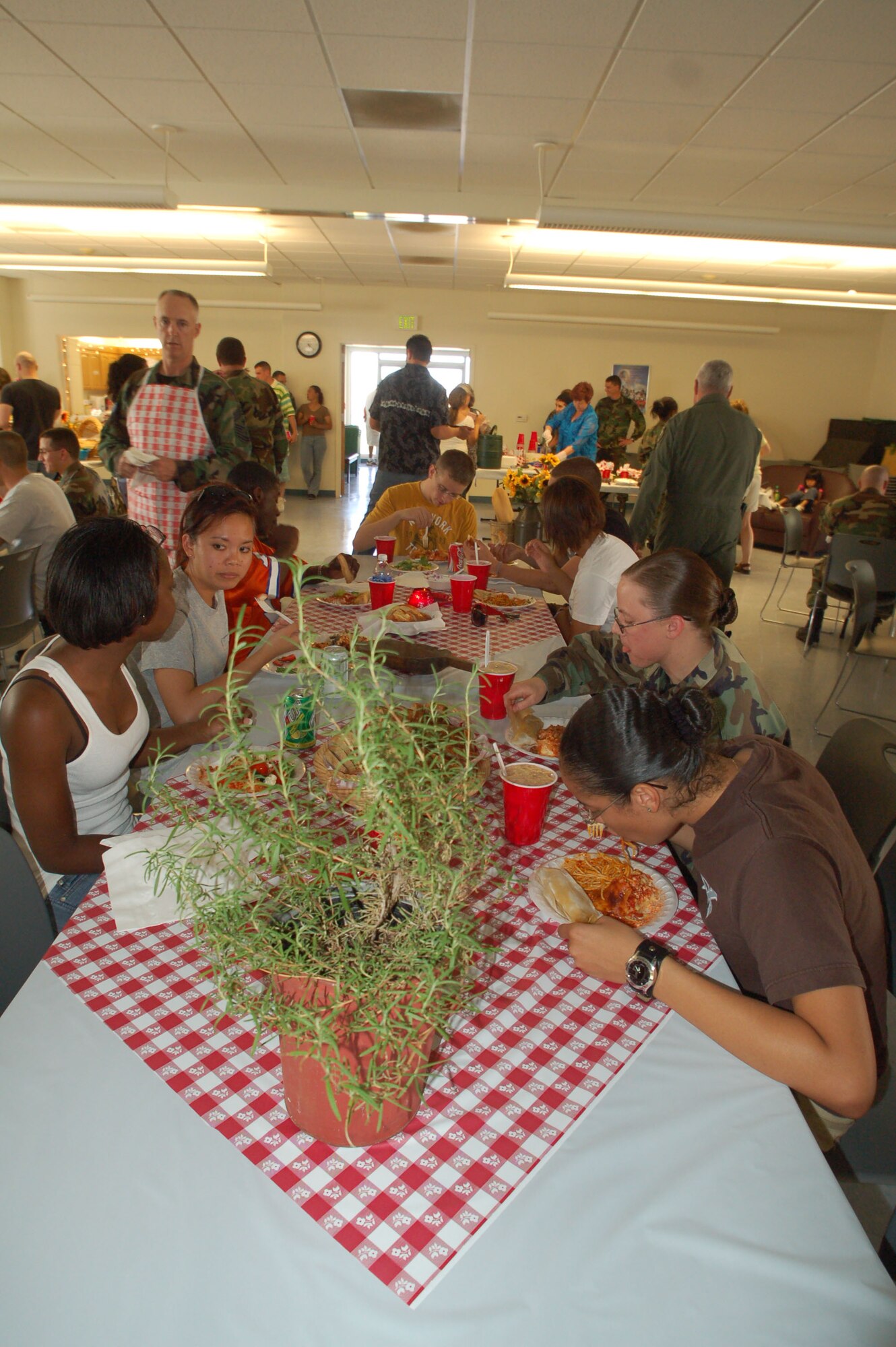 Edwards servicemembers enjoy their home-cooked meal served by various base organizations at Chapel 1 here July 12. More than 50 servicemembers participated in the event. (Photo by Airman 1st Class Julius Delos Reyes)