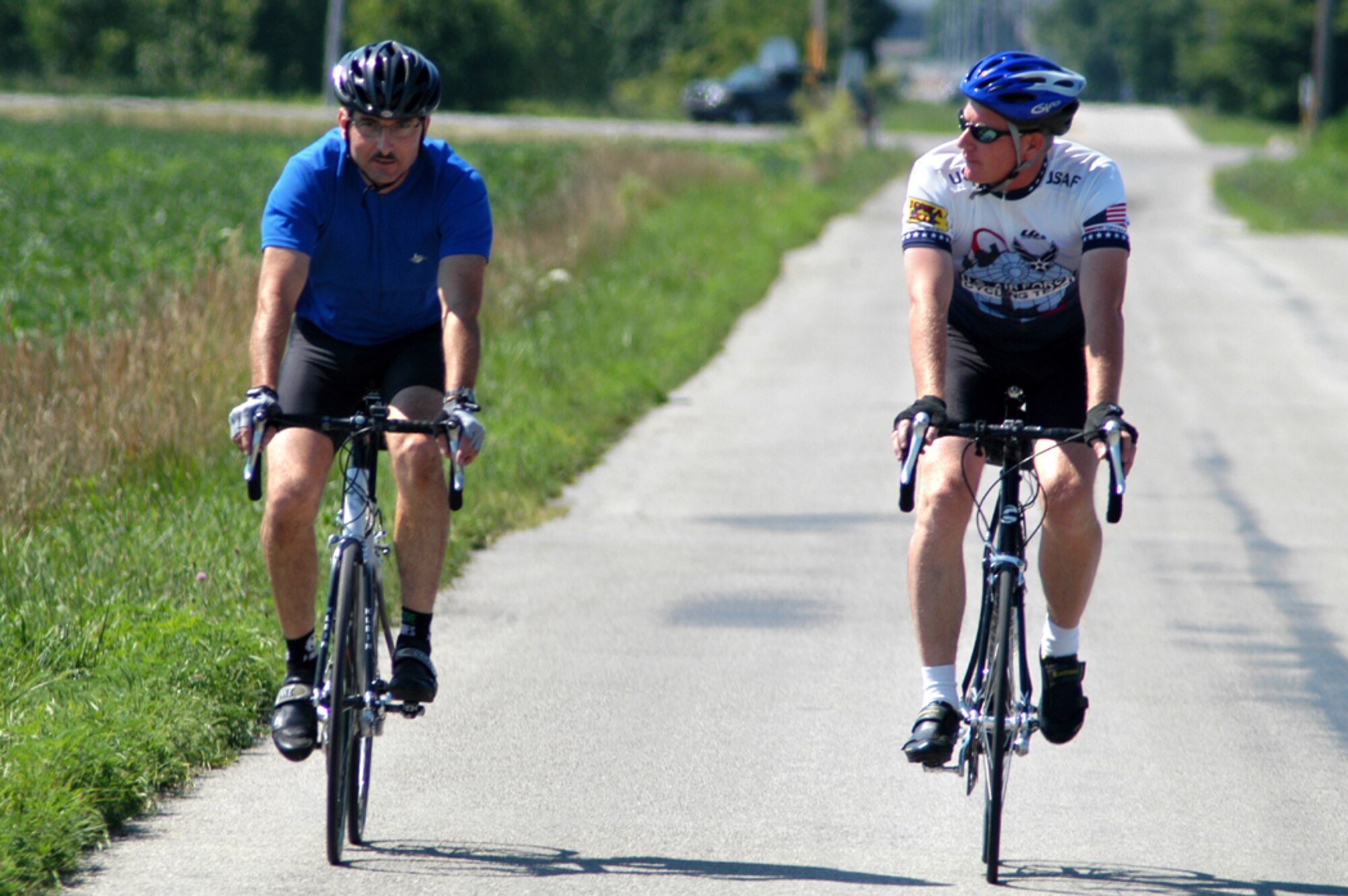 GRISSOM AIR RESERVE BASE, Ind. -- Tech. Sgt. Mark Wilson (left) and Senior Master Sgt. Richard Scully pedal up County Road 400 near Grissom. The two are training to ride in the Register's Annual Great Bicycle Ride Across Iowa as part of an Air Force team. Sergeant Wilson is a 434th Aircraft Maintenance Squadron communications and navigations systems technician and Sergeant Scully is a 434th Maintenance Group quality assurance technician. (U.S. Air Force photo/Staff Sgt. Mark Orders-Woempner)