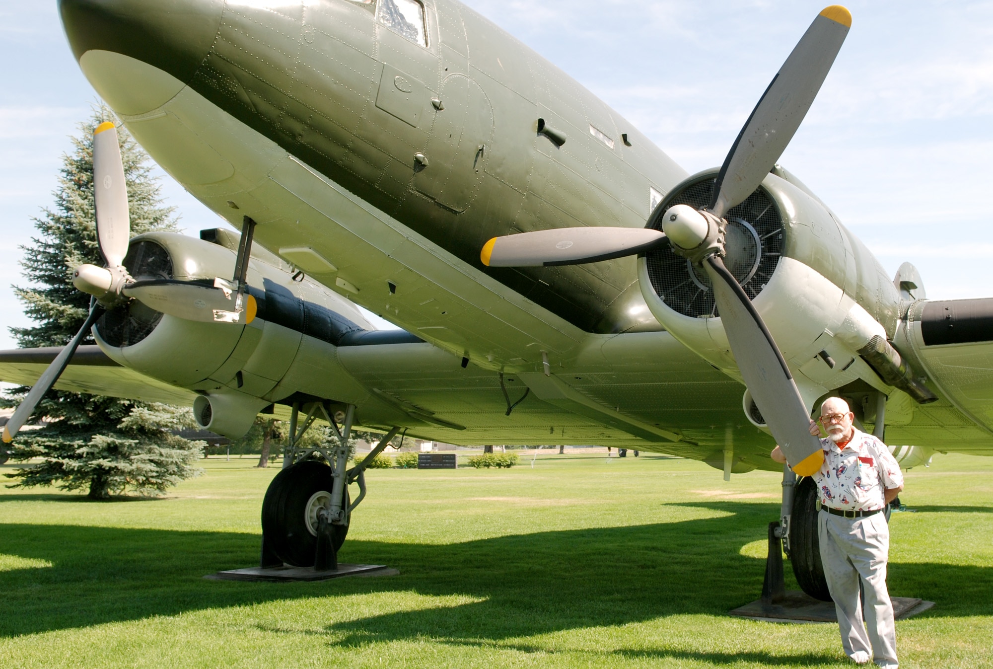 FAIRCHILD AIR FORCE BASE, Wash. – Retired Maj. Malcolm A. Stewart stands next to the Douglas C-47 Skytrain, also nicknamed “Gooney Bird”, at the Hertiage Park here. Major Stewart, former public relations officer at Fairchild from 1956 to 1960, was back in the Spokane area to attend his 68th high school reunion.  He also had the opportunity to fly the CE4 glider, B-24 Liberator, B-17 Flying Fortress, P-47 Thunderbolt, the P-51 Mustang, P-38 Lightning, Douglas A-26 Invader, Noorduyn UC 64 Norseman, Douglas A-20 Havoc, AT6 Texan as well as other training aircraft with the Army Air Corp. (U.S. Air Force photo/ Tech. Sgt. Larry W. Carpenter Jr.)