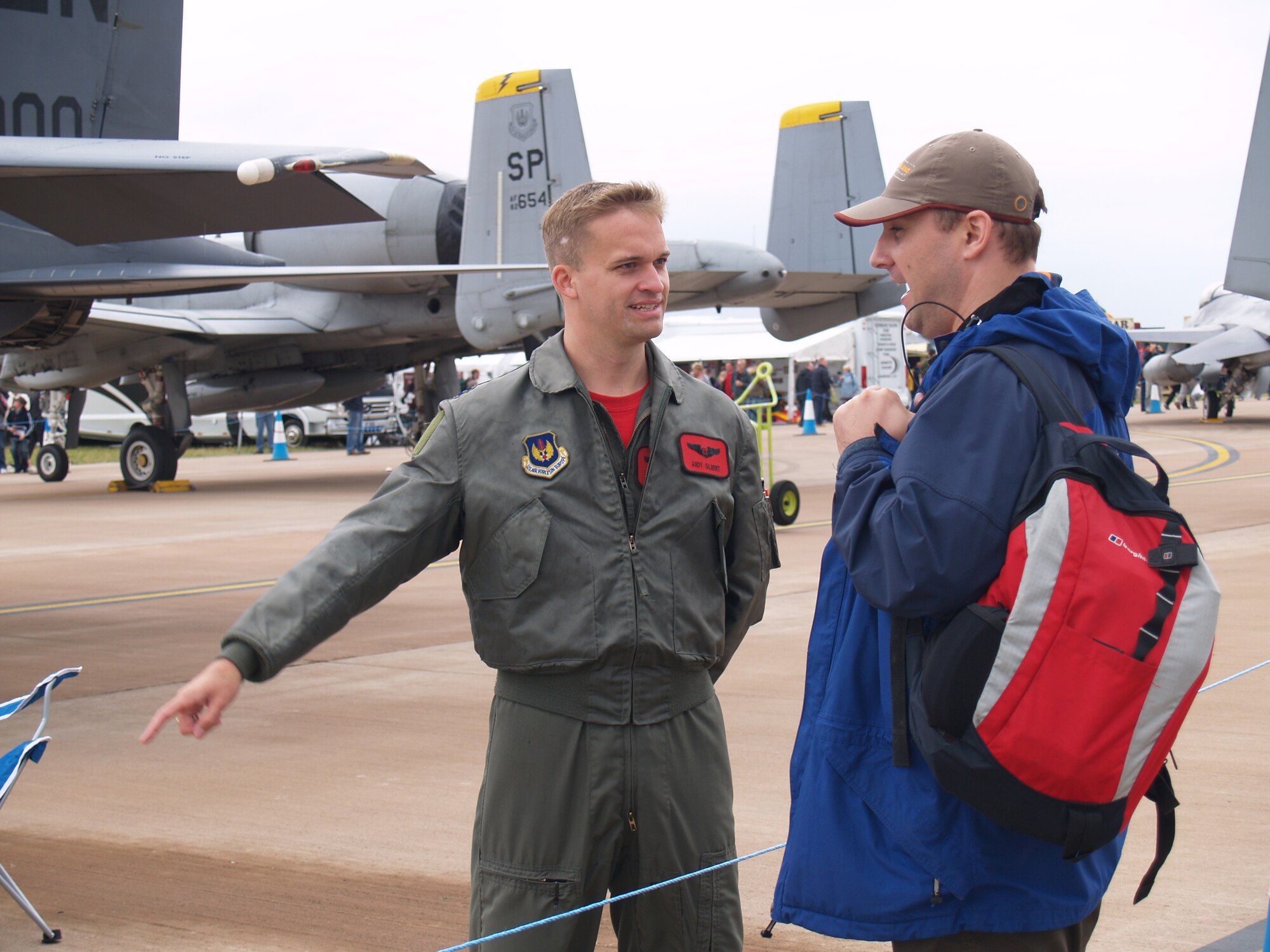 Captain Andy "ACE" Gilbert, an F-15E weapons system officer with the 494th Fighter Squadron from Royal Air Forces Lakenheath, England, discusses the capabilities of his Strike Eagle with spectator James Denning at the Royal International Air Tattoo. RIAT is the world's largest military air show. (U.S. Air Force photo/Tech. Sgt Carl E. RIshkofski) 