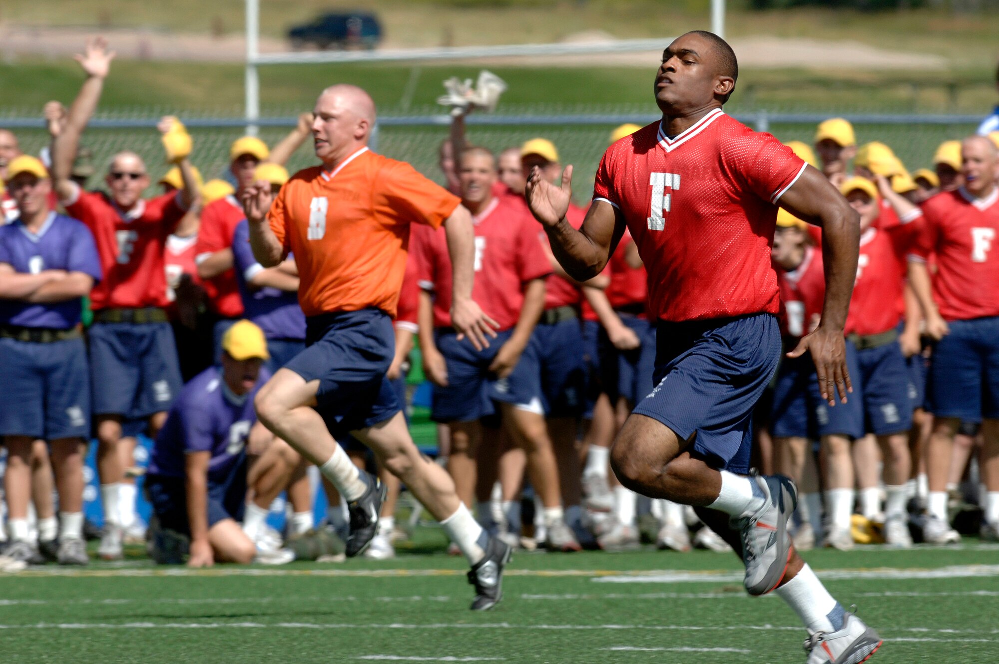 Basic cadet trainees sprint across the field at Field Day July 14 at the U.S. Air Force Academy in Colorado. New cadets are in their first month of training at the Academy and are learning honor, discipline and integrity in addition to physical fitness. (U.S. Air Force photo/Mike Kaplan)
