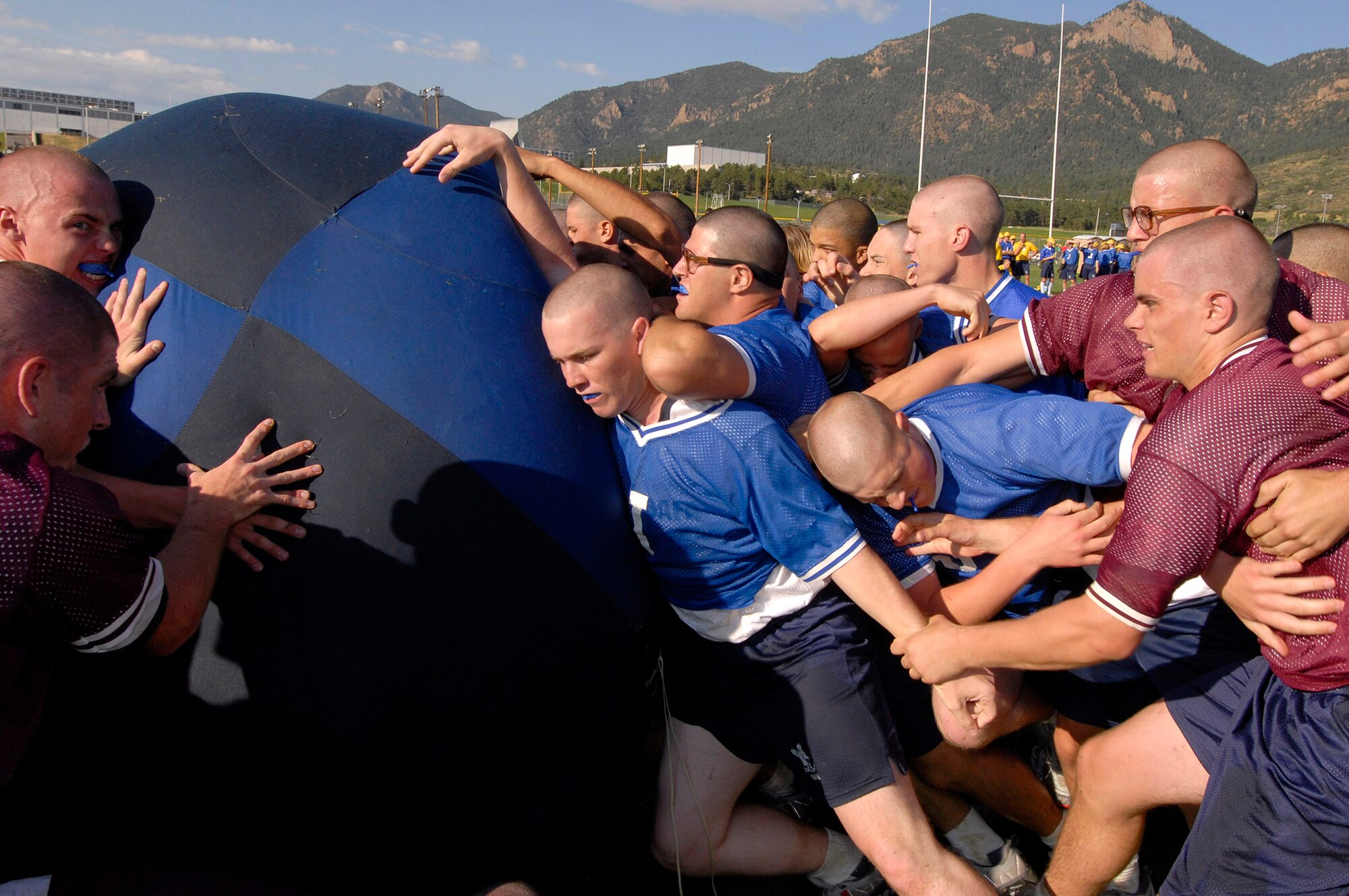 Basic cadet trainees bunch up playing push ball at Field Day July 14 at the U.S. Air Force Academy in Colorado. Push ball is a highly charged contest where cadets push a large sphere across a goal line. New cadets are in their first month of training at the Academy and are learning honor, discipline and integrity in addition to physical fitness. (U.S. Air Force photo/Mike Kaplan) 