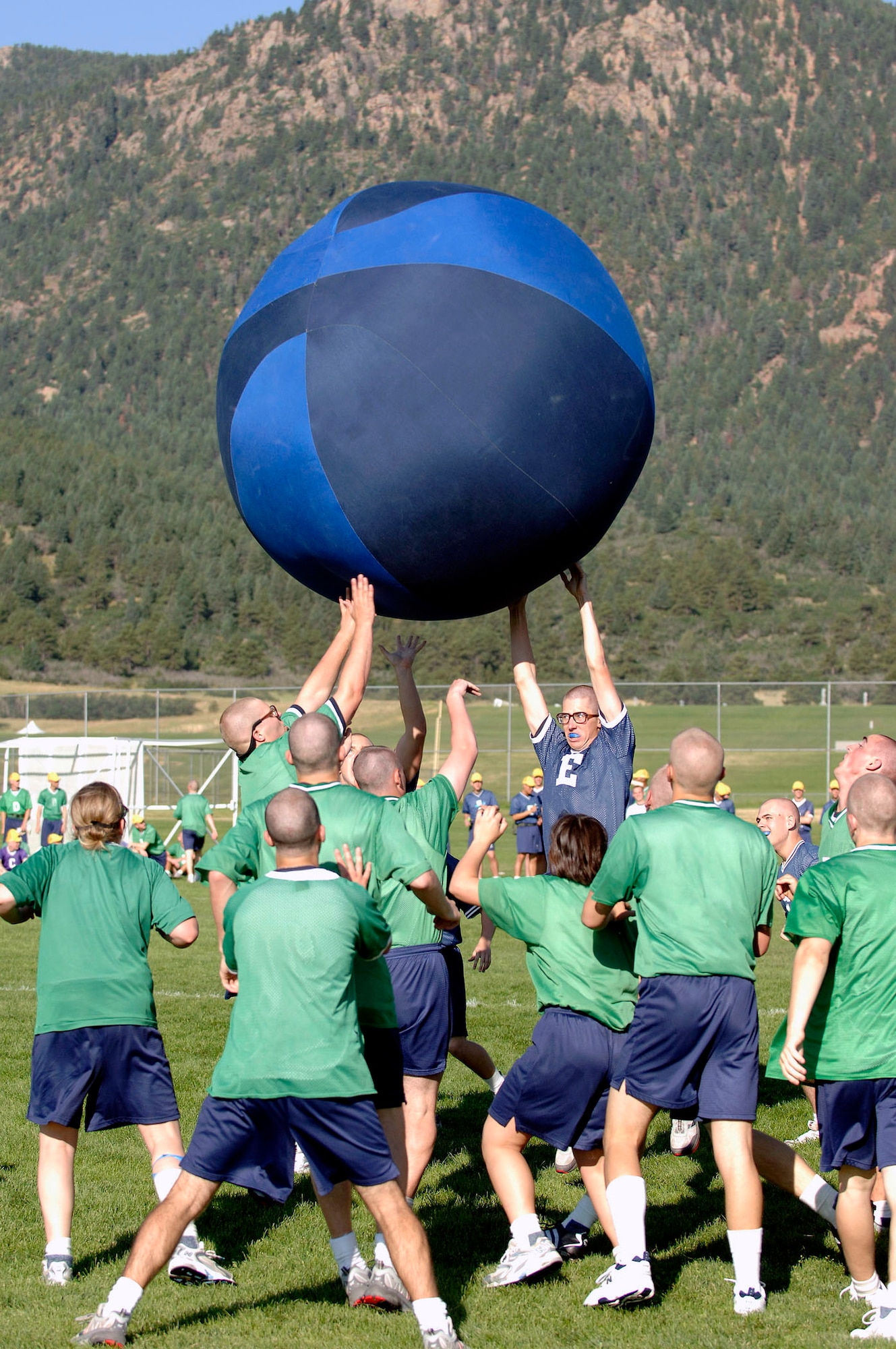 Basic cadet trainees play push ball at Field Day July 14 at the U.S. Air Force Academy, Colo. Push ball is a highly charged contest where cadets push a large sphere across a goal line. New cadets are in their first month of training at the Academy and are learning about honor, discipline and integrity in addition to physical fitness. (U.S. Air Force photo/Mike Kaplan)
