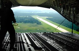 U.S. Air Force Chief Master Sgt. Roger Morris, a loadmaster with the 14th Airlift Squadron, Charleston Air Force Base, S.C., watches a pallet drop out of the main cargo door of a Charleston C-17 Globemaster III during a joint service airdrop training exercise July 12, 2007. (U.S. Air Force Photo/Airman 1st Class Nicholas Pilch)