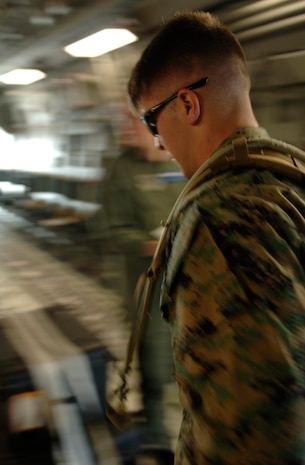 U.S. Marine Corps Cpl. John Powell, a parachute rigger in the 2nd Air Delivery Unit out of Camp Lejeune, N.C., loads a Charleston C-17 Globemaster III July 12, 2007 on the Charleston AFB, S.C., flightline. Cpl. Powell was part of a joint service training on Charleston. (U.S. Air Force Photo/Airman 1st Class Nicholas Pilch)