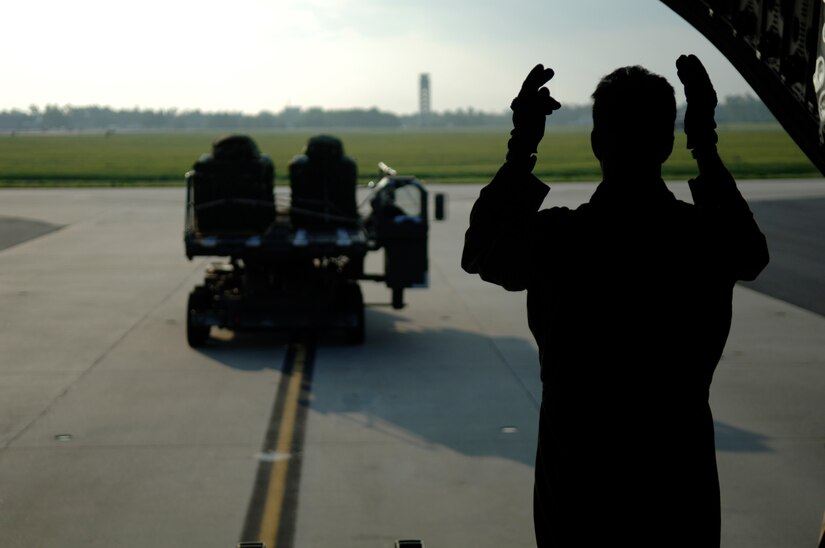 U.S. Air Force Master Sgt. Johnny Bartosh, loadmaster in the 317th Airlift Squadron, taxi's in a 437th Aerial Port Squadron K-Loader carrying aerial delivery exercise containers for a joint service airdrop July 12, 2007 at Charleston AFB, S.C.(U.S. Air Force Photo/Airman 1st Class Nicholas Pilch)