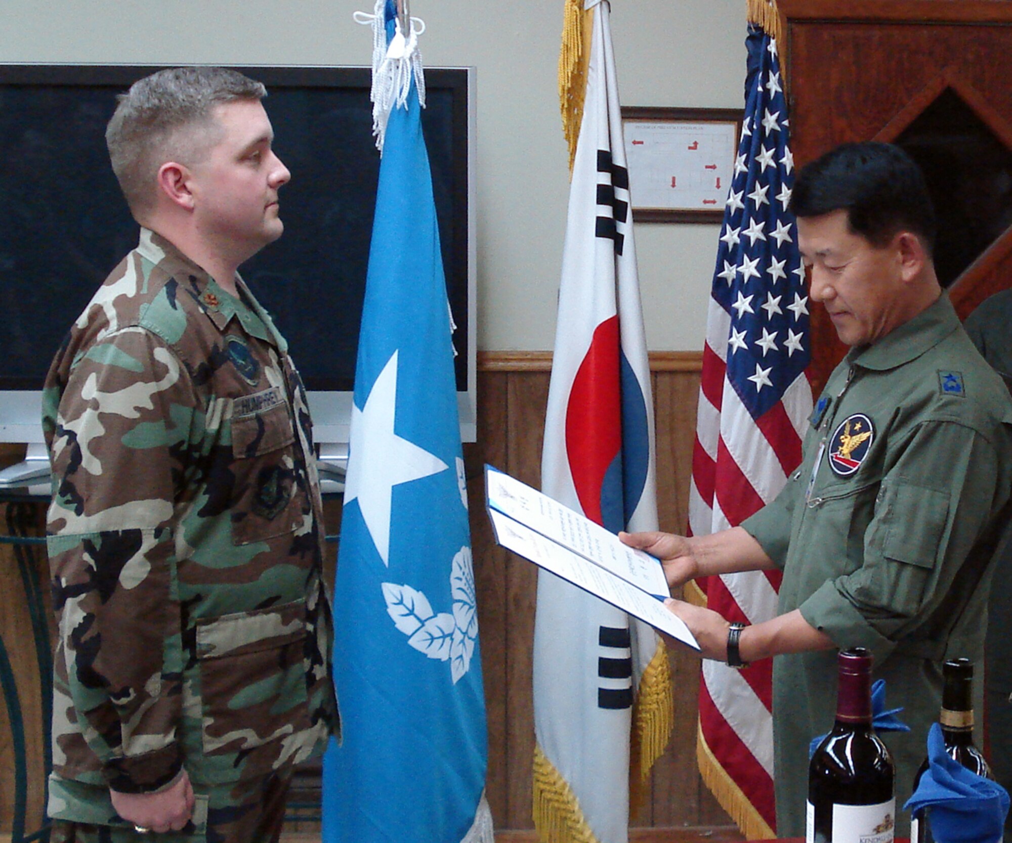 Brigadier General Kwon, Oh Sung commander 1st Fighter Wing, Republic of Korea Air Force(Right) presents Major Jason K. Humphrey commander, detachment 1, 607th materiel maintenance squadron(Left) with a Letter of Commendation for the meritorious efforts that he and the detachment have rendered to the 1st Fighter Wing.  Major Humphrey hosted a friendship dinner for the ROKAF 1st Fighter Wing leadership and the 607th Air Support Group.  The dinner was held at the Detachment 1’s recreation center at Gwang Ju Air Baseon 12 July, 2007.  (Courtesy Photo)