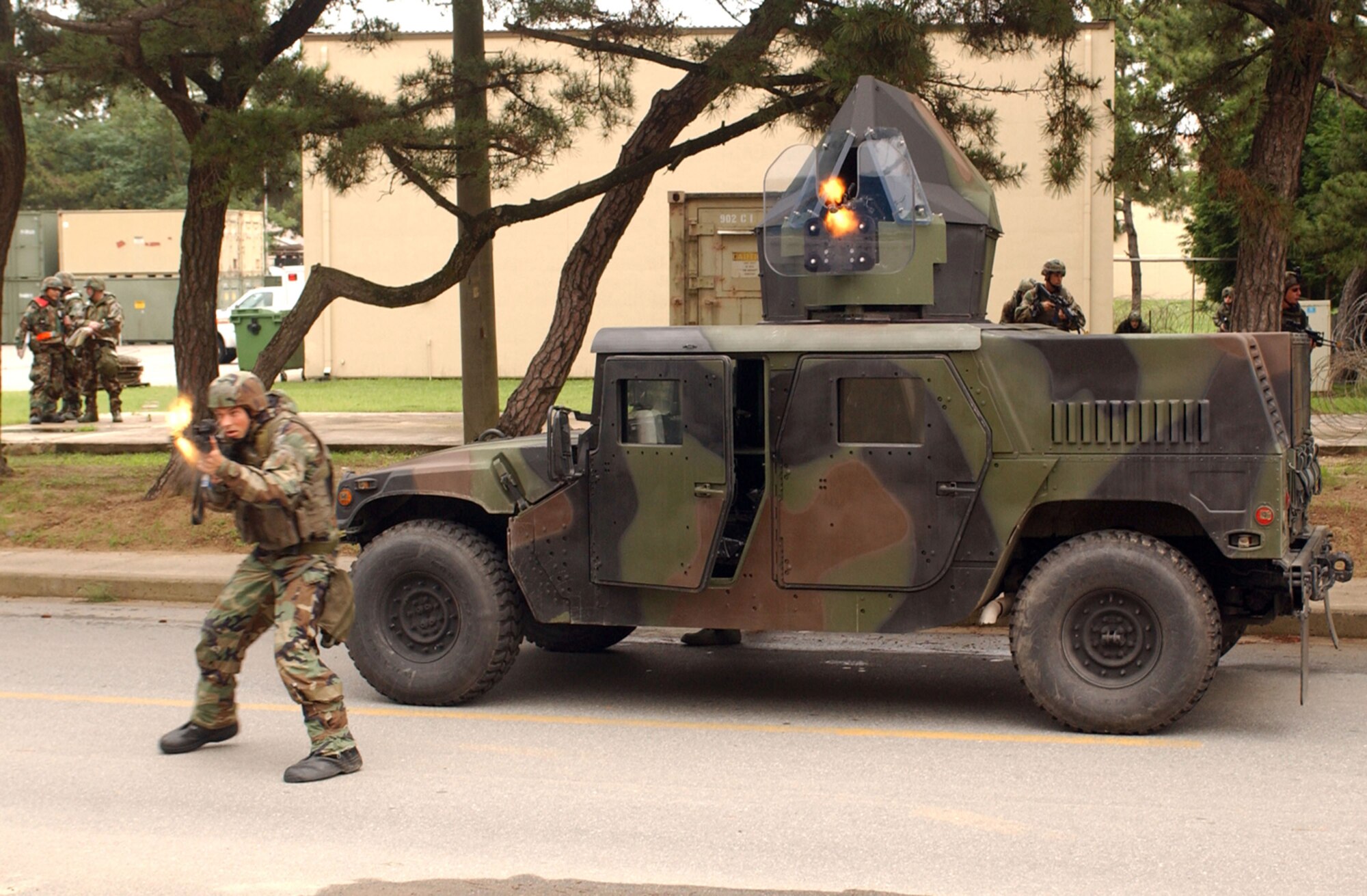 KUNSAN AIR BASE, Republic of Korea -- Two Airmen from the 8th Security Forces Squadron respond to a scenario against opposing forces with small arms fire during Wolf War Days on July 17. The Airmen are participating in a two-day exercise preparing 8th Fighter Wing Airmen for the upcoming Korean peninsula exercise next week along with potential real world scenarios. (U.S. Air Force Photo/Senior Airman Steven R. Doty)                           