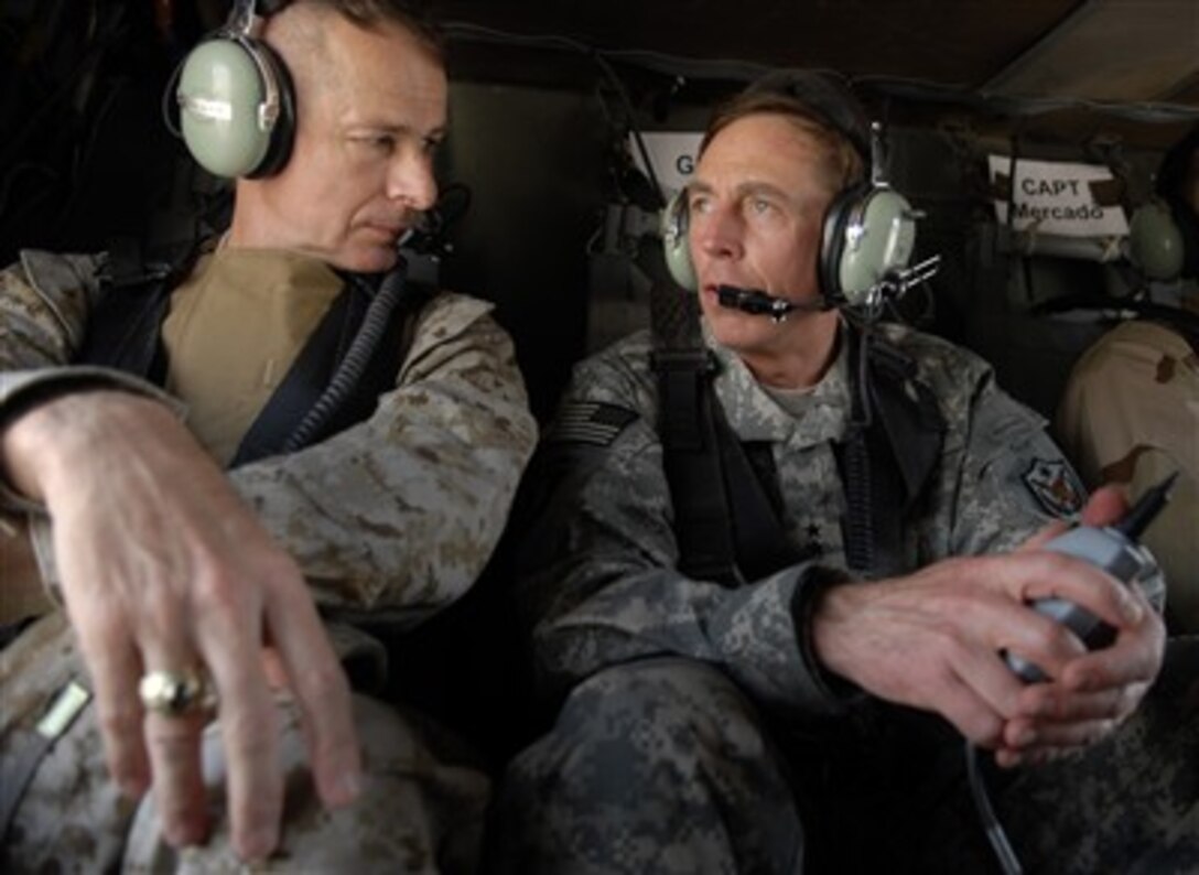 Commander of Multi-National Force - Iraq Gen. David Petraeus (right), U.S. Army, and Chairman of the Joint Chiefs of Staff Gen. Peter Pace, U.S. Marine Corps, discuss the situation on the ground in Iraq as they helicopter to the Green Zone in Baghdad, Iraq, on July 16, 2007.  Pace is visiting Iraq to meet Petraeus and other senior leaders, visit troops and to assess the operations in Iraq.  
