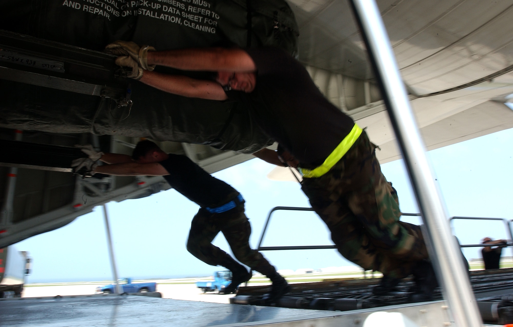 Staff Sgts. James Cantu, Lance Schutts and Alejandro Castillo, from the 733rd Air Mobility Squadron, push a heavy piece of cargo onto an L-100 civilian aircraft at Kadena Air Base, Japan, July 19. The plane travels to Osan AB, Korea; Yokota, AB, Misawa AB and Kadena three times a week delivering and picking up equipment.
U.S. Air Force photo/Staff Sgt. Reynaldo Ramon
