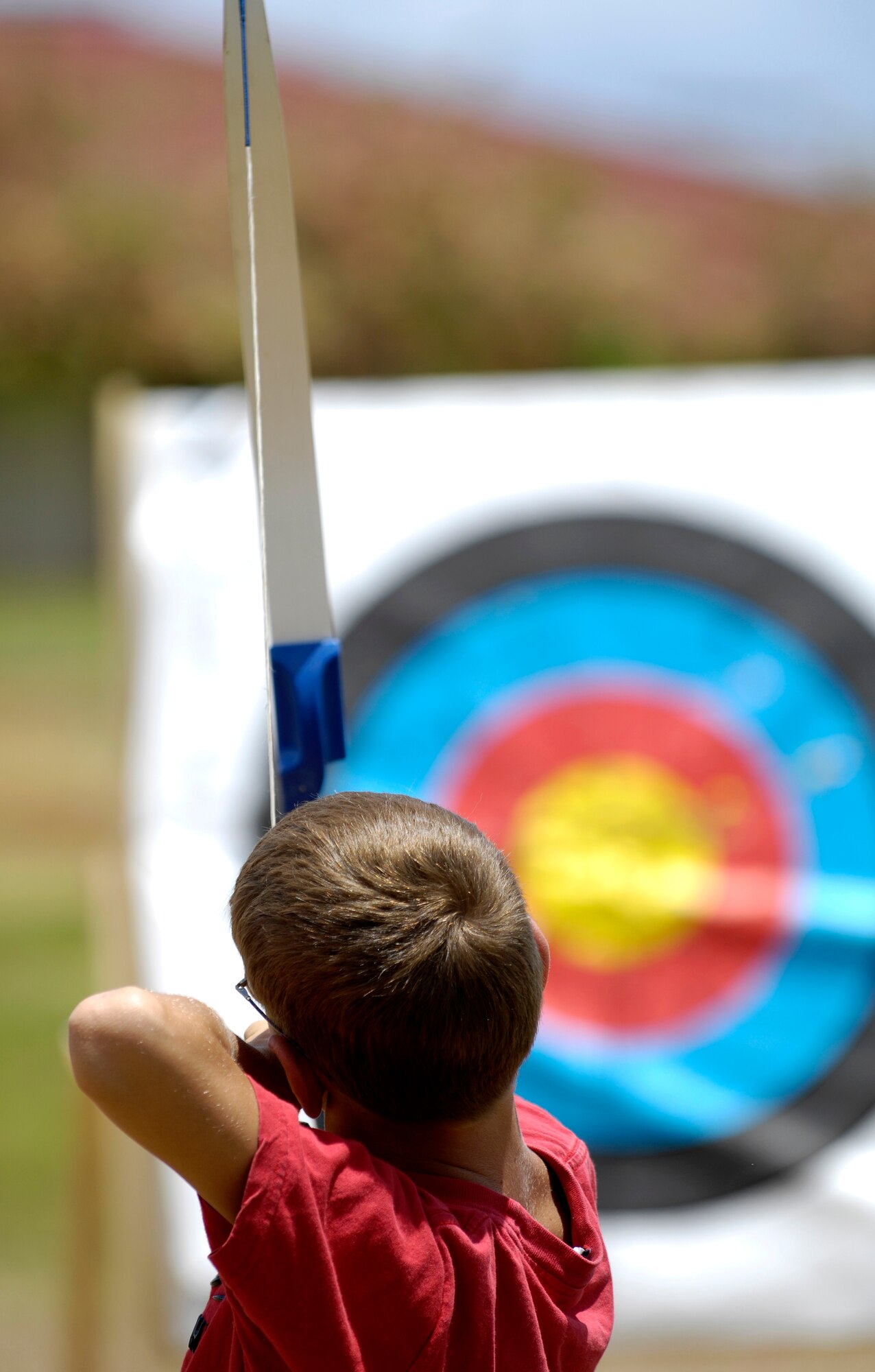 Dillon Leggett, 11, aims at a target during archery lessons at the Community Activity Center here. Dillon is the son of Tech. Sgt. Mike Leggett. (U.S. Air Force photo/Tech. Sgt. Shane A. Cuomo)