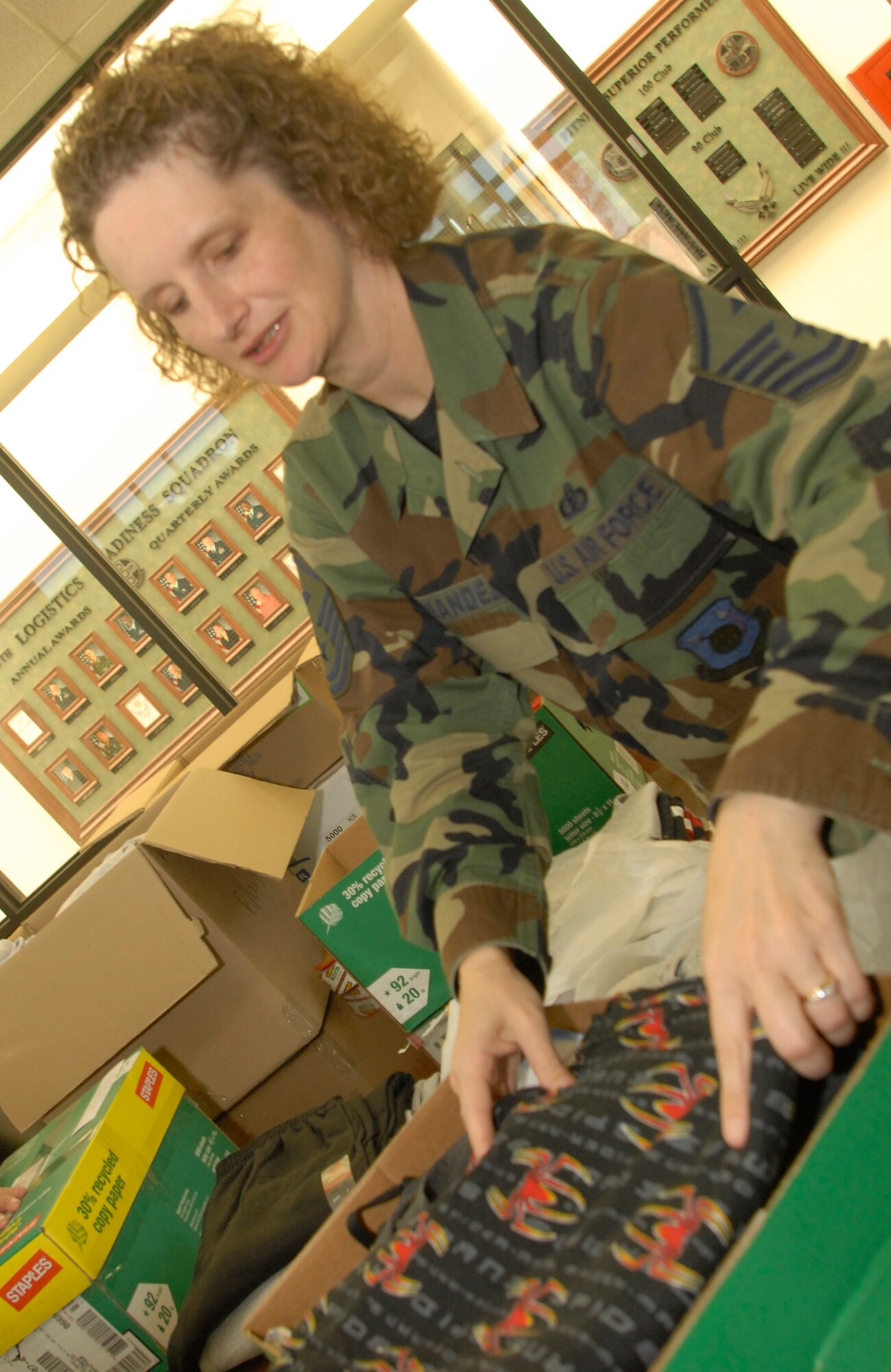 VANDENBERG AIR FORCE BASE, Calif. - Master Sgt. Angela Fernandez, 1st Sgt. for the 30th Medical Group, prepares boxes on July 19 to be shipped to Iraq, part of Operation Warrior Comfort at the Logistic Readiness Squadron's Building. Operation Warrior Comfort provides support for the Contingency Air Staging Facility, or CSAF, that cares for sick and wounded Airmen and Soldiers transiting through on their way to Germany for care. The donations that have been fundraised through Operation Warrior Comfort will  provide some of the wounded troops with clothes since most of them arrive to the CASF with nothing but the clothes on their backs. (U.S. Air Force Photo by Senior Airman Kristi Emler)