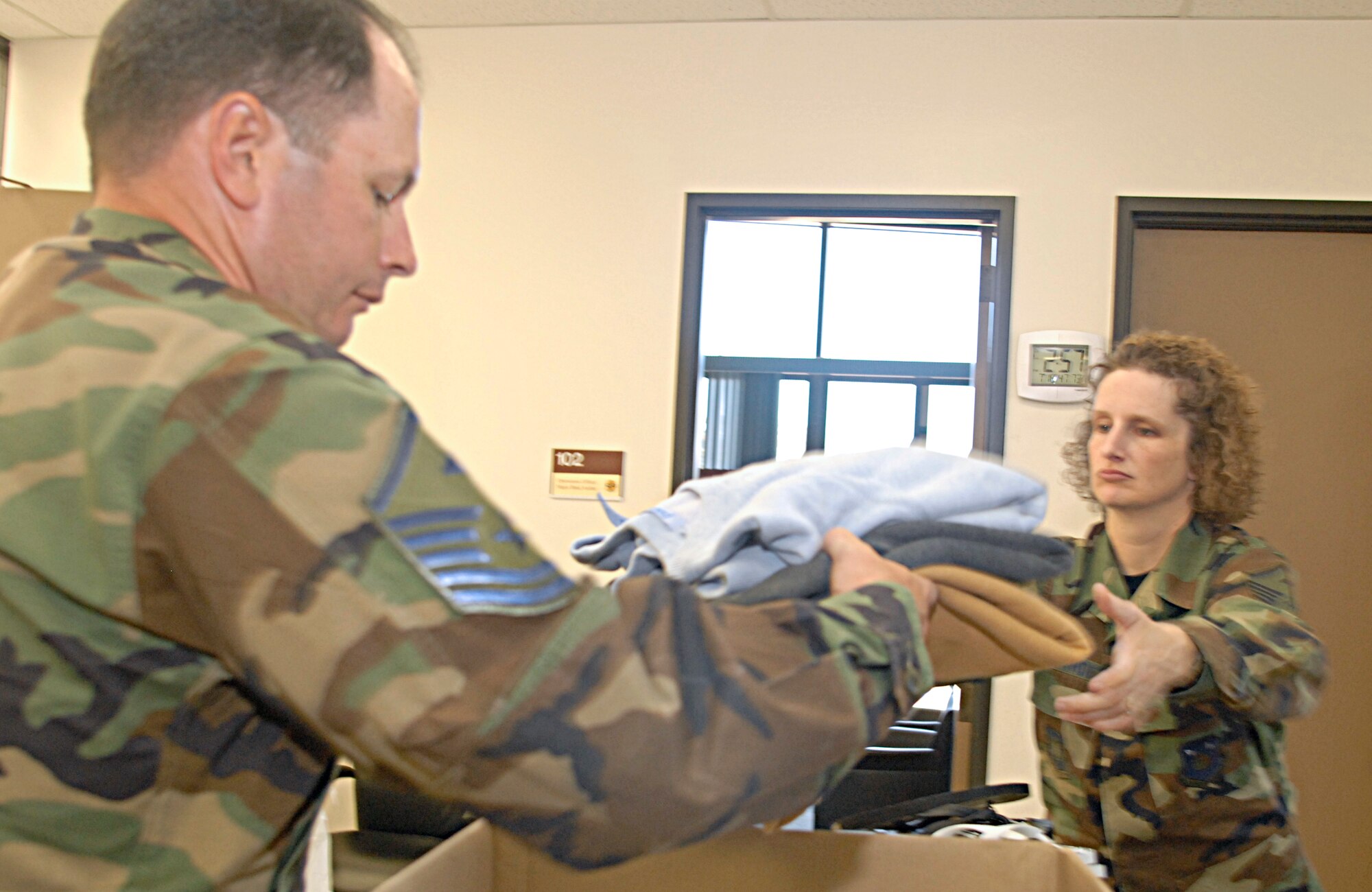 VANDENBERG AIR FORCE BASE, Calif. - Master Sgt. Angela Fernandez, 1st Sgt. for the 30th Medical Group, along with Master Sgt. Michael Jones, 1st Sgt. for the 30th Civil Engineer Squadron, prepare boxes on July 19 to be shipped to Iraq, part of Operation Warrior Comfort at the Logistic Readiness Squadron's Building. Operation Warrior Comfort provides support for the Contingency Air Staging Facility, or CSAF, that cares for sick and wounded Airmen and Soldiers transiting through on their way to Germany for care. The donations that have been fundraised through Operation Warrior Comfort will  provide some of the wounded troops with clothes since most of them arrive to the CASF with nothing but the clothes on their backs. (U.S. Air Force Photo by Senior Airman Kristi Emler)