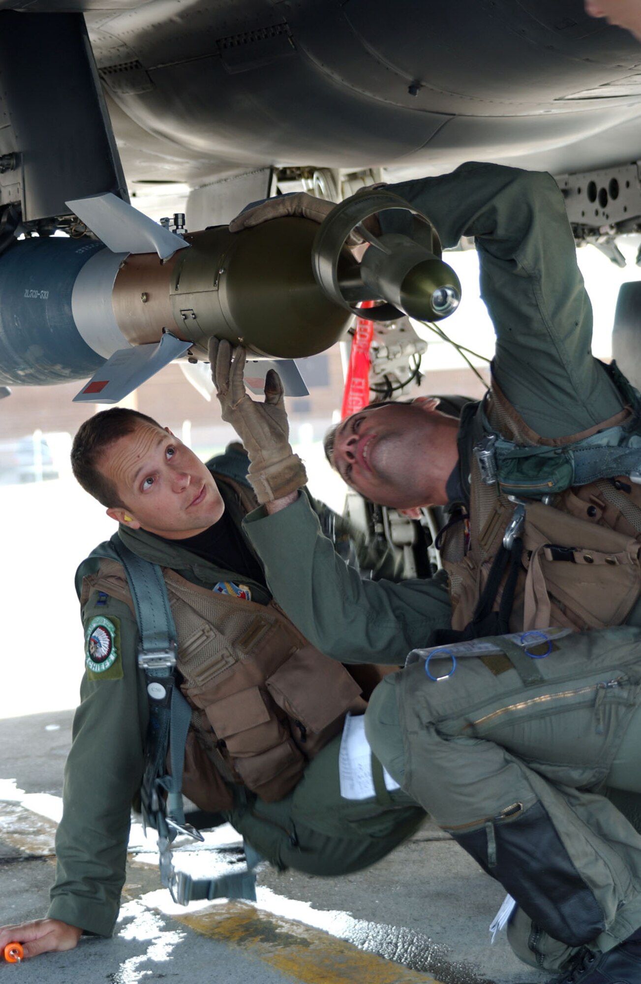 Strike Eagle weapon sysytems officer Capt Chris Beery watches his pilot, Capt Kevin Pritz, during a pre-flight check of the F-15E Strike Eagle before a coalition mission at Eielson AFB for Red Flag Alaska July 17, 2007. The jet and crew are deployed from the 335th Fighter Squadron from Seymour Johnson AFB, N.C.  (U.S. Air Force photo by Capt. Tana R.H. Stevenson)                                                        