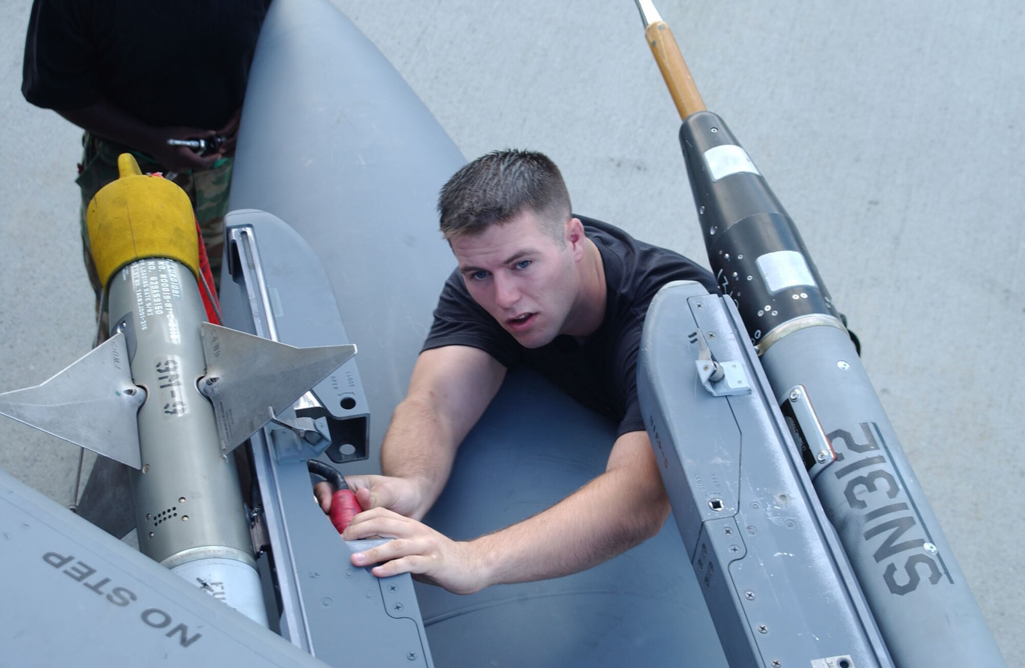 EIELSON AIR FORCE BASE, Alaska -- A1C Jacob Trowbridge, 4th Fighter Wing, Seymour Johnson AFB, NC., connects a CAP-9 missile on an F-15E Strike Eagle before a mission at Red Flag-Alaska July 16, 2007. This exercise provides unique opportunities to help integrate various forces into joint, coalition, and bilateral training from simulated forward operating bases.  (U.S. Air Force photo by Capt. Tana R.H. Stevenson) 