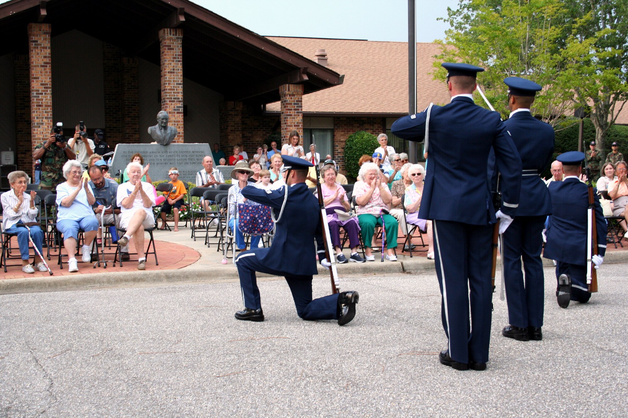 Airmen from the Air Force Honor Guard drill team complete a five-man precision drill routine for residents at the Air Force Enlisted Village July 13.  Following the demonstration, the Airmen attended a reception with AFEV residents at Bob Hope Village.  (Courtesy photo)