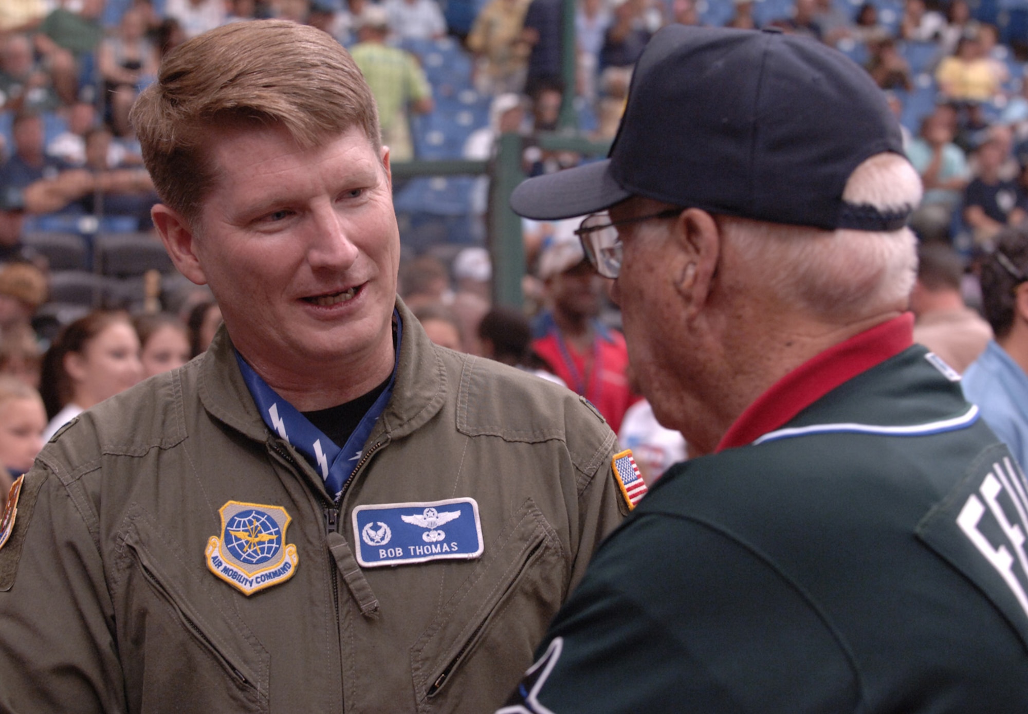 Col. Robert Thomas, 6th Air Mobility Wing commander, meets with Bob Feller, former Wolrd War II veteran and Major League Baseball Hall of Famer, before the Tampa Bay Devil Rays baseball game against the New York Yankees at Tropicana Field in St. Petersburg, Fla., July 16.  They both each threw ceremonial first pitches for Miltary Appreciation Day at Tropicana Field.