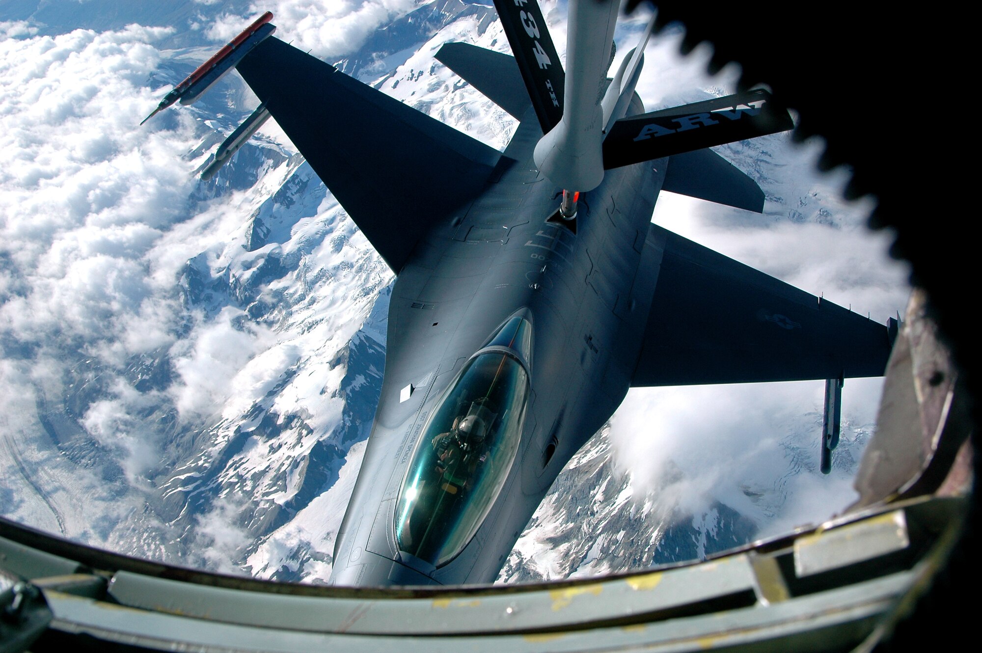 A KC-135 Stratotanker from Grissom Air Reserve Base, Ind., provides in-flight refueling to an F-16 Fighting Falcon from Eielson Air Force Base, Alaska, over the Pacific Alaska Range Complex, America’s largest training range, during Red Flag-Alaska, July 16. Red Flag-Alaska is a multinational air combat training exercise that began July 12 and will conclude July 28. (U.S. Air Force photo by Staff Sgt. Shawn J. Jones)