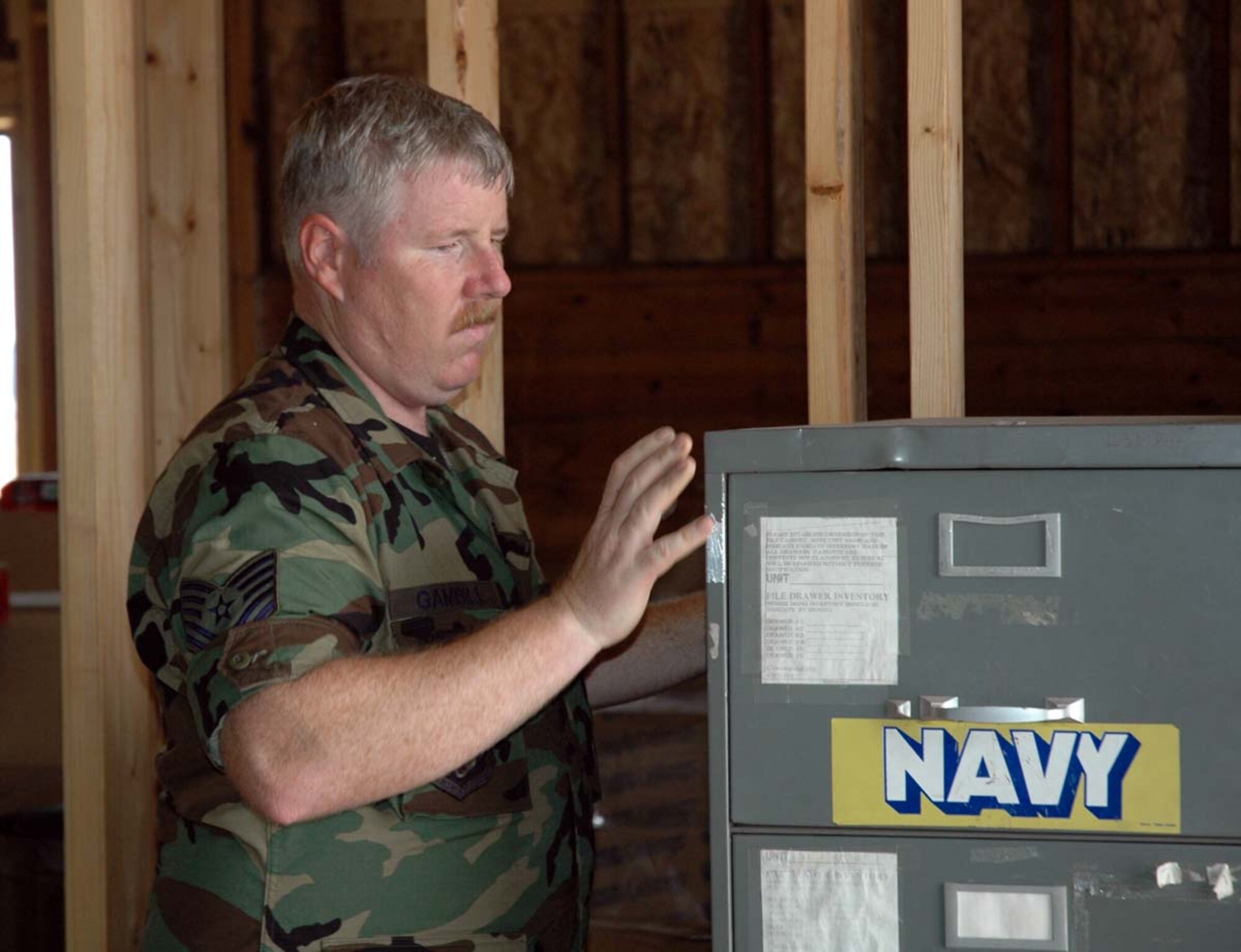 Tech. Sgt. John Gambill, 944th Civil Engineer Squadron structural craftsman, moves office equipment during a renovation of office space at Camp Navajo near Flagstaff, Ariz. (U.S. Air Force photo/Staff. Sgt. Steve Razo)
