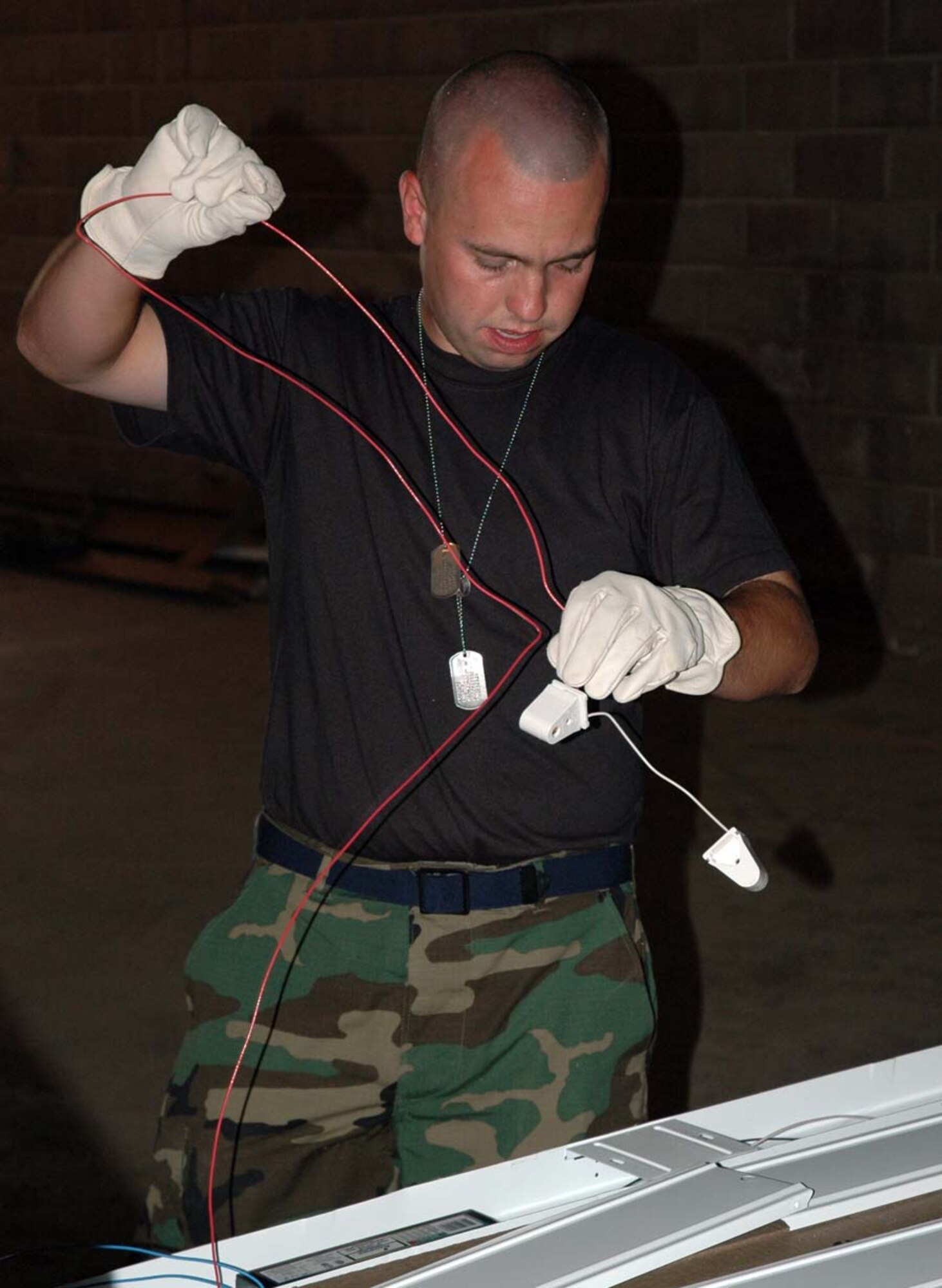 Senior Airman Chad Goerndt, 944th Civil Engineer Squadron, assembles light fixtures during building renovations at Camp Navajo near Flagstaff, Ariz. (U.S. Air Force photo/Staff Sgt. Steve Razo)