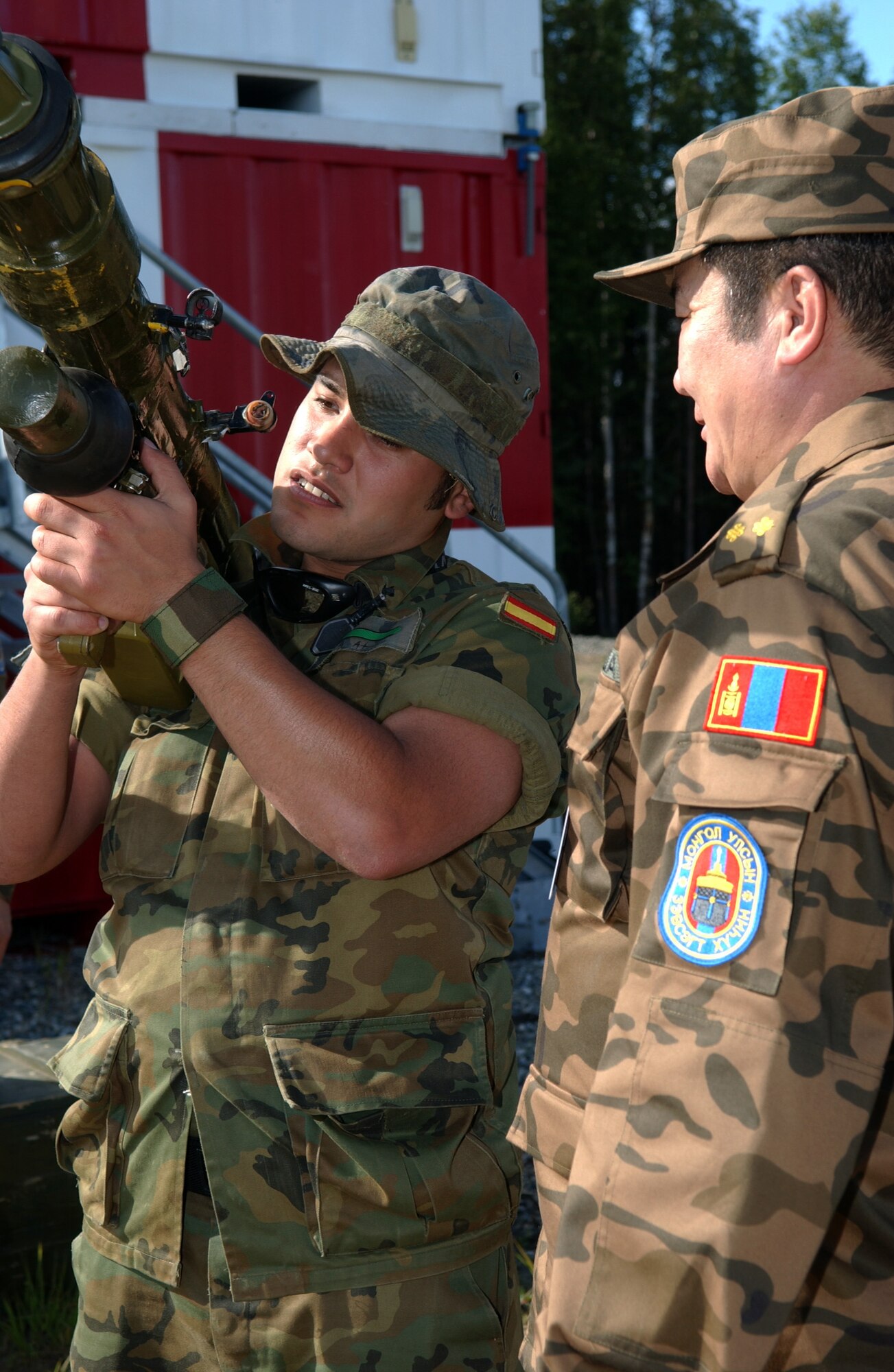 EIELSON AIR FORCE BASE, Alaska -- Lt. Col. Jigjid Batsukh (Right), Mongolian Air Defense Force, instructs Airman Basic Hugo Lesta (Left), Spanish Air Force, the operation of an SA-7 Man-portable air-defense systems (surface to air missile launcher) on the Pacific Alaskan Range Complex on July 16 during Red Flag-Alaska 07-3. The PARC provides 67,000 square miles of airspace, one conventional bombing range and two tactical bombing ranges containing more than 400 different types of targets and more than 30 threat simulators which allows them to exchange tactics, techniques, and procedures and improve interoperability. (U.S. Air Force Photo by Airman 1st Class Jonathan Snyder)
