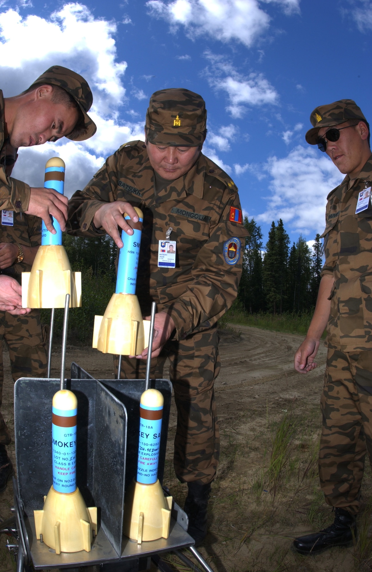 EIELSON AIR FORCE BASE, Alaska -- Sgt. Danaasuren Neggui (Left), Lt. Col. Jigjid Batsukh (Center), Staff Sgt. Munkhuu Batmunkh (Right), Mongolian Air Defense Force, places the Smokey Sam ground to air missile into the launcher on the Pacific Alaskan Range Complex on July 16 during Red Flag-Alaska 07-3. The PARC provides 67,000 square miles of airspace, one conventional bombing range and two tactical bombing ranges containing more than 400 different types of targets and more than 30 threat simulators which allows them to exchange tactics, techniques, and procedures and improve interoperability. (U.S. Air Force Photo by Airman 1st Class Jonathan Snyder) 